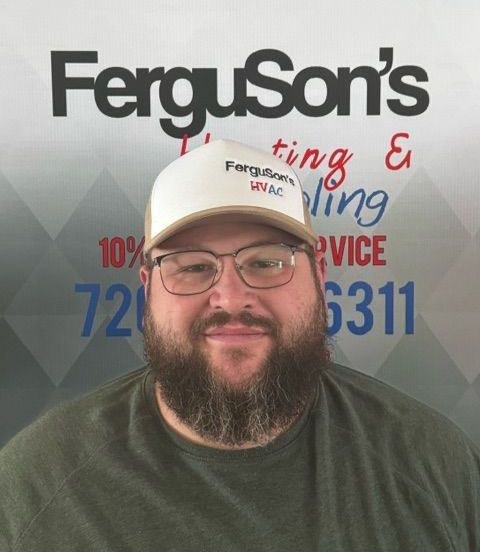 A man with a beard and glasses is wearing a ferguson 's hat