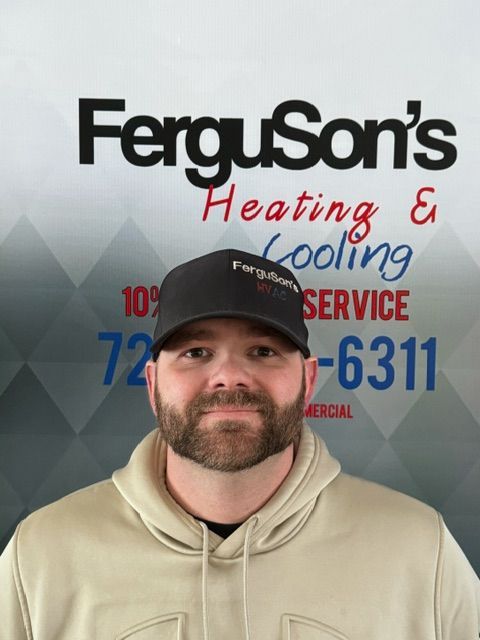 A man standing in front of a sign for ferguson 's heating and cooling service