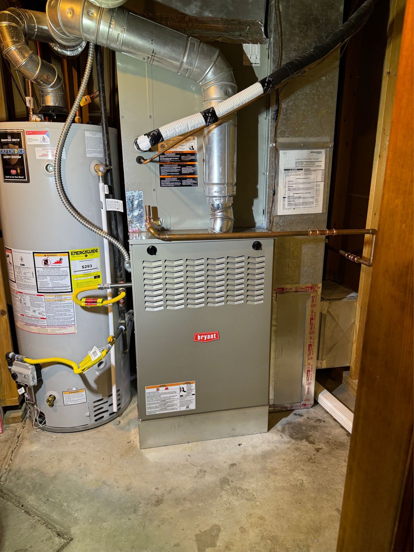 A man is working on a heating system in a garage.