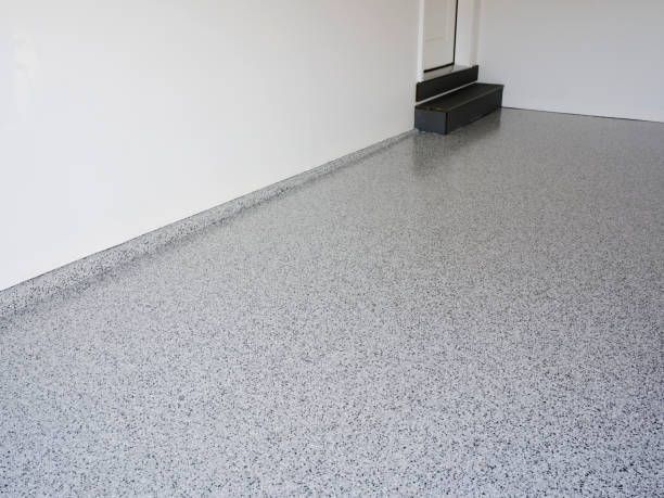 A garage with a gray floor and white walls.