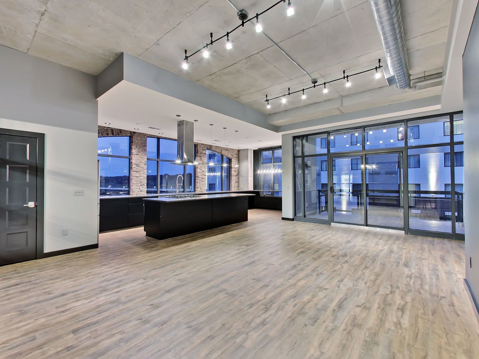 Northside lofts large living room with big windows and patio