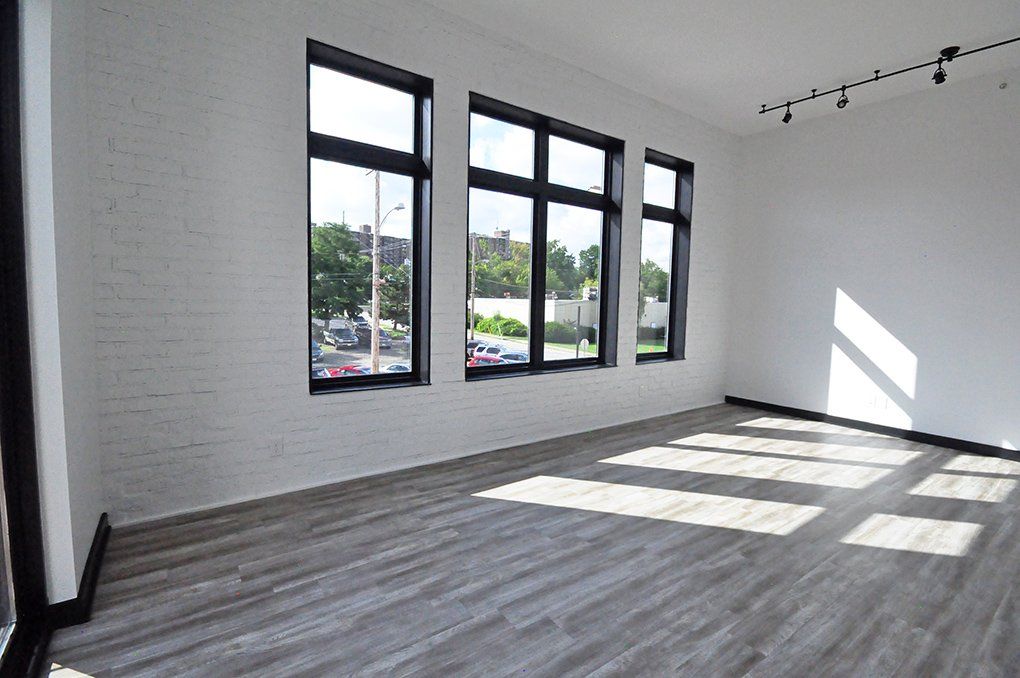 living room with large windows and vinyl flooring