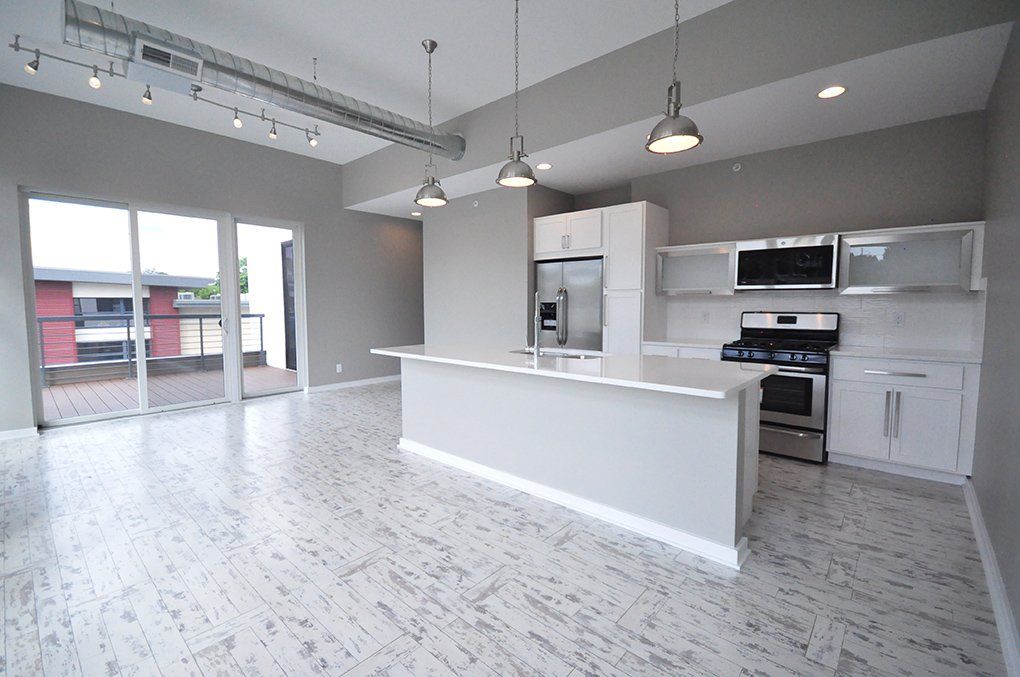 large kitchen with living room and sliding glass door