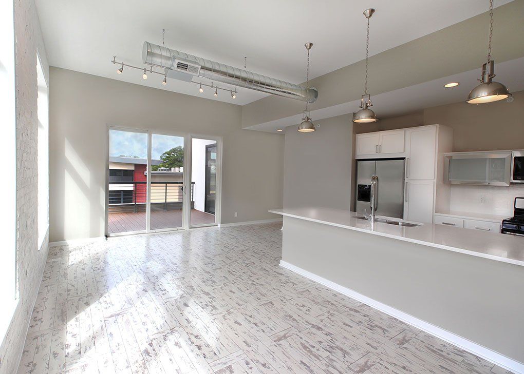 large living room with balcony and kitchen