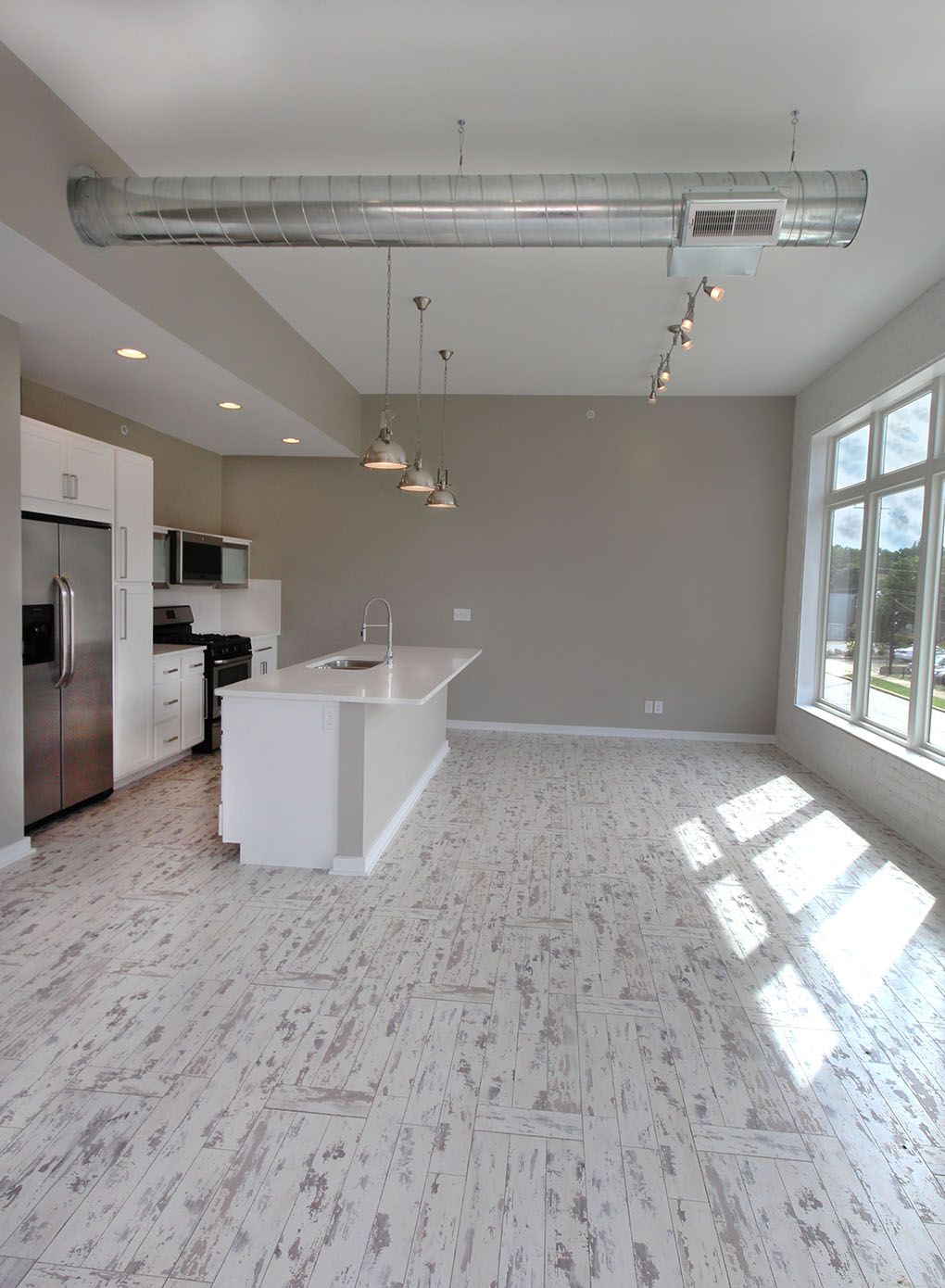 large living room with balcony and kitchen