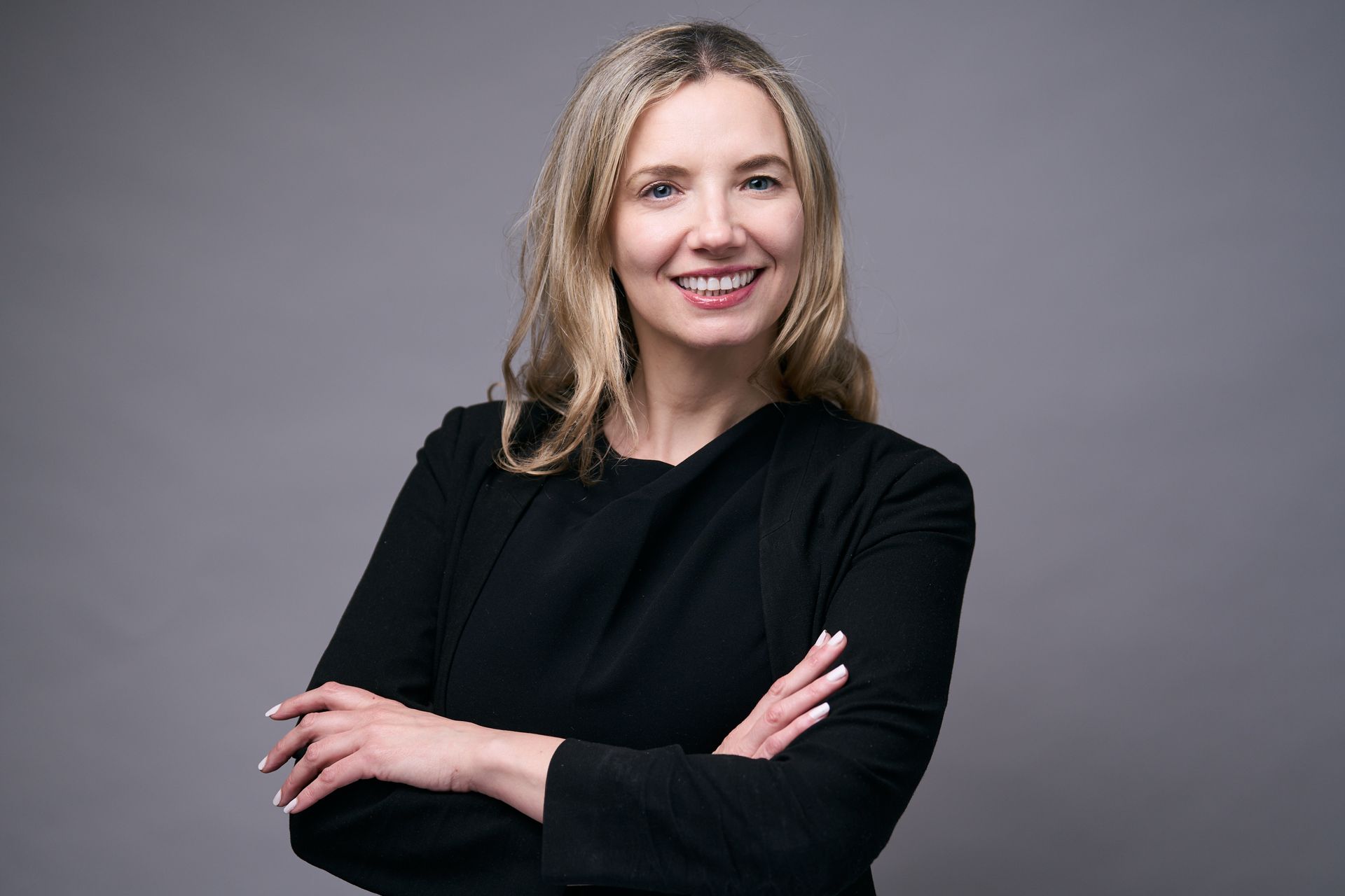 A woman is giving a presentation to a group of people.