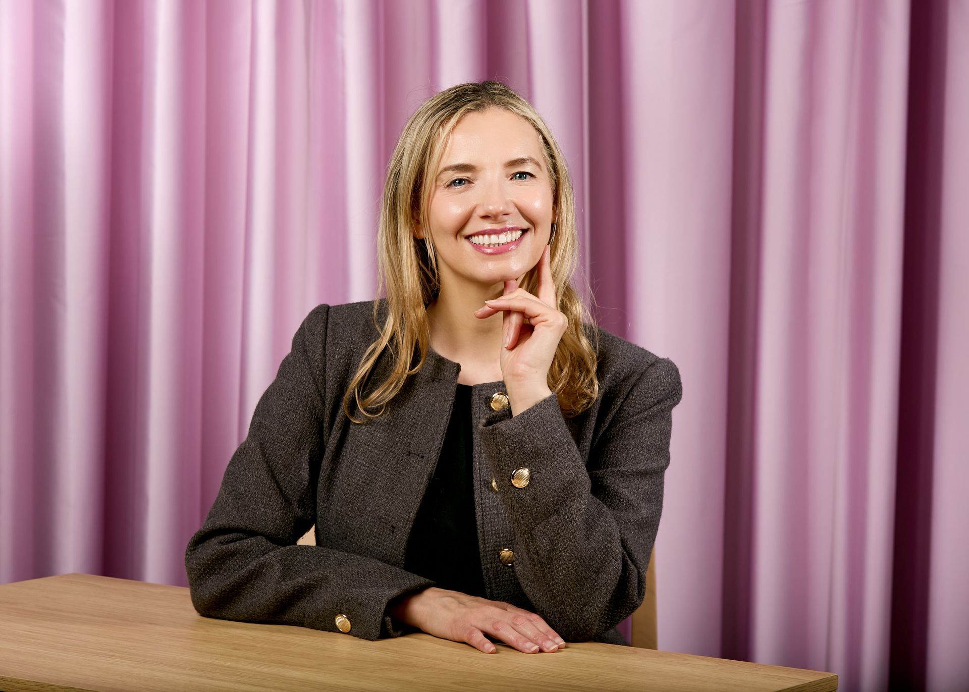 A woman is sitting in a lotus position in front of a camera.