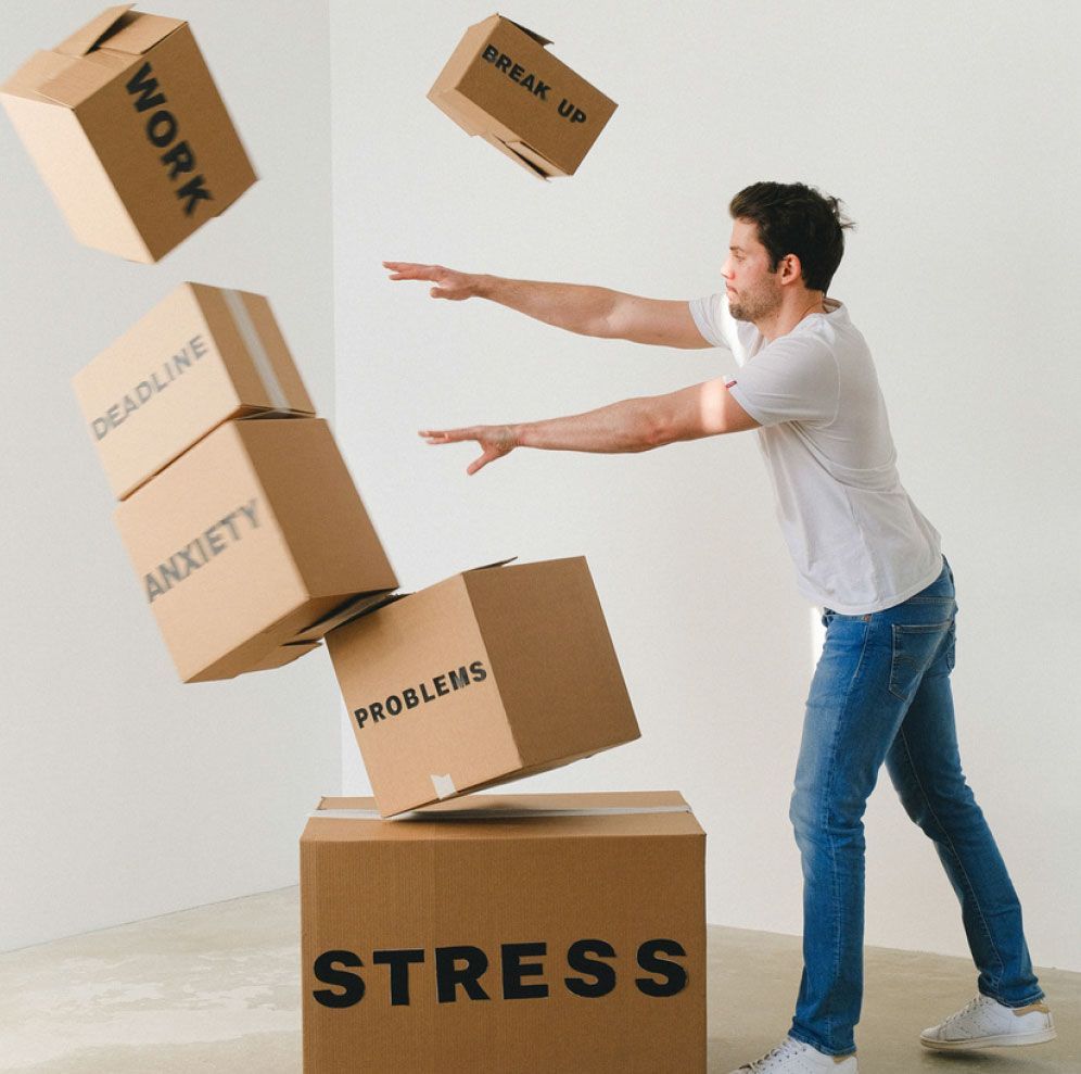 A man standing next to a box that says stress