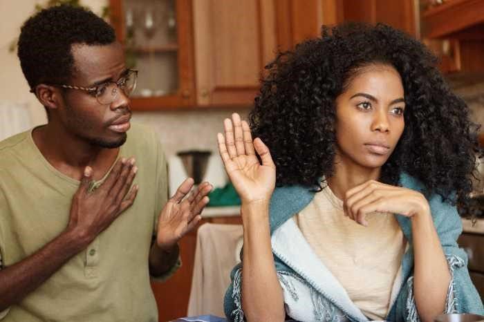 A man and a woman are having an argument in a kitchen.