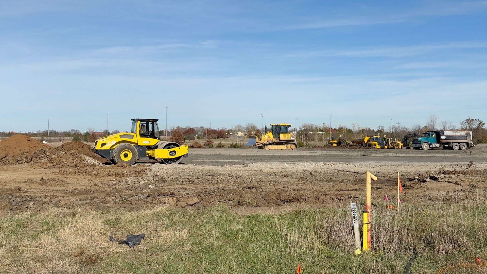 A group of construction vehicles are working on a construction site.