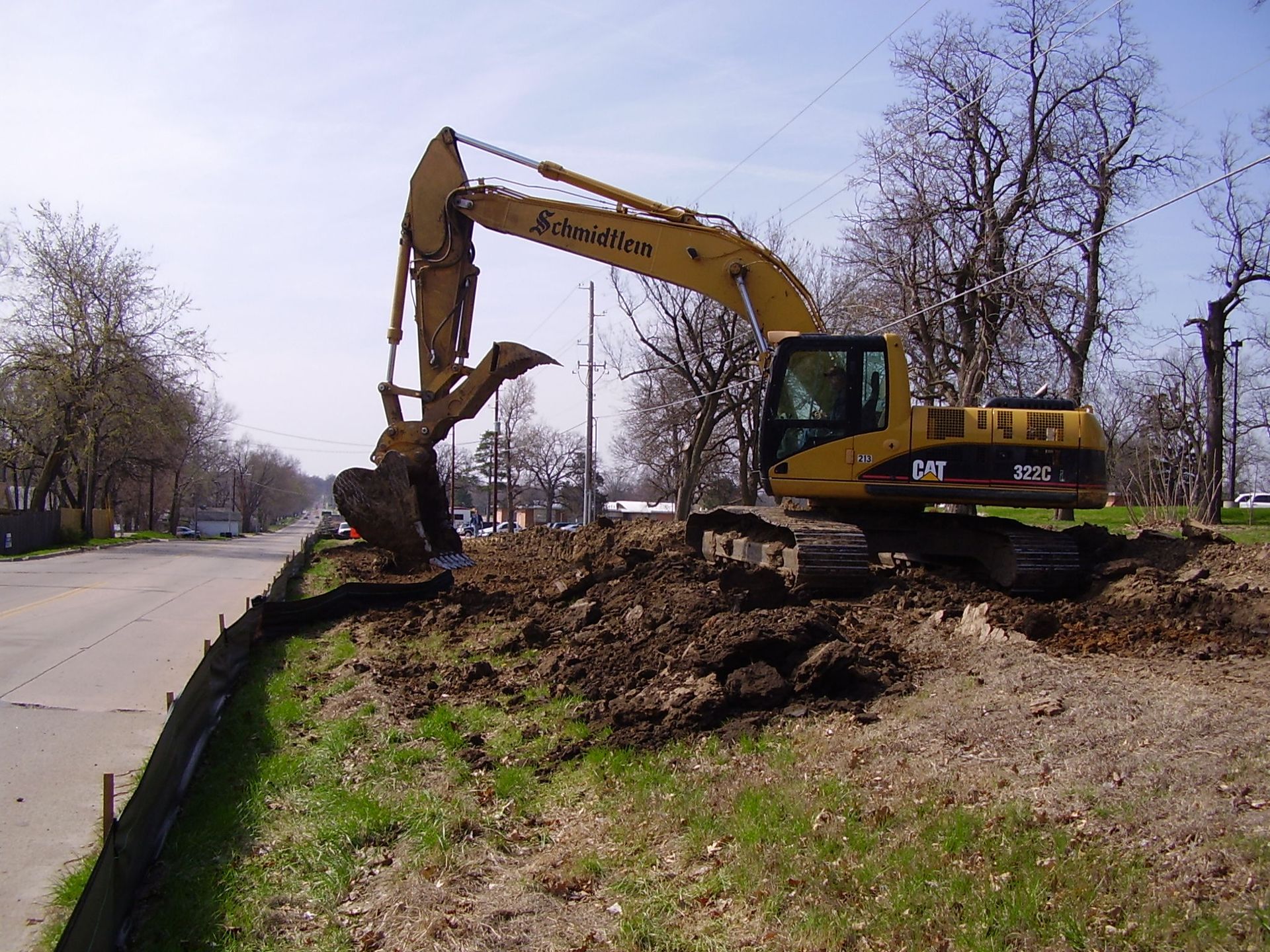 A yellow excavator with the word cat on it