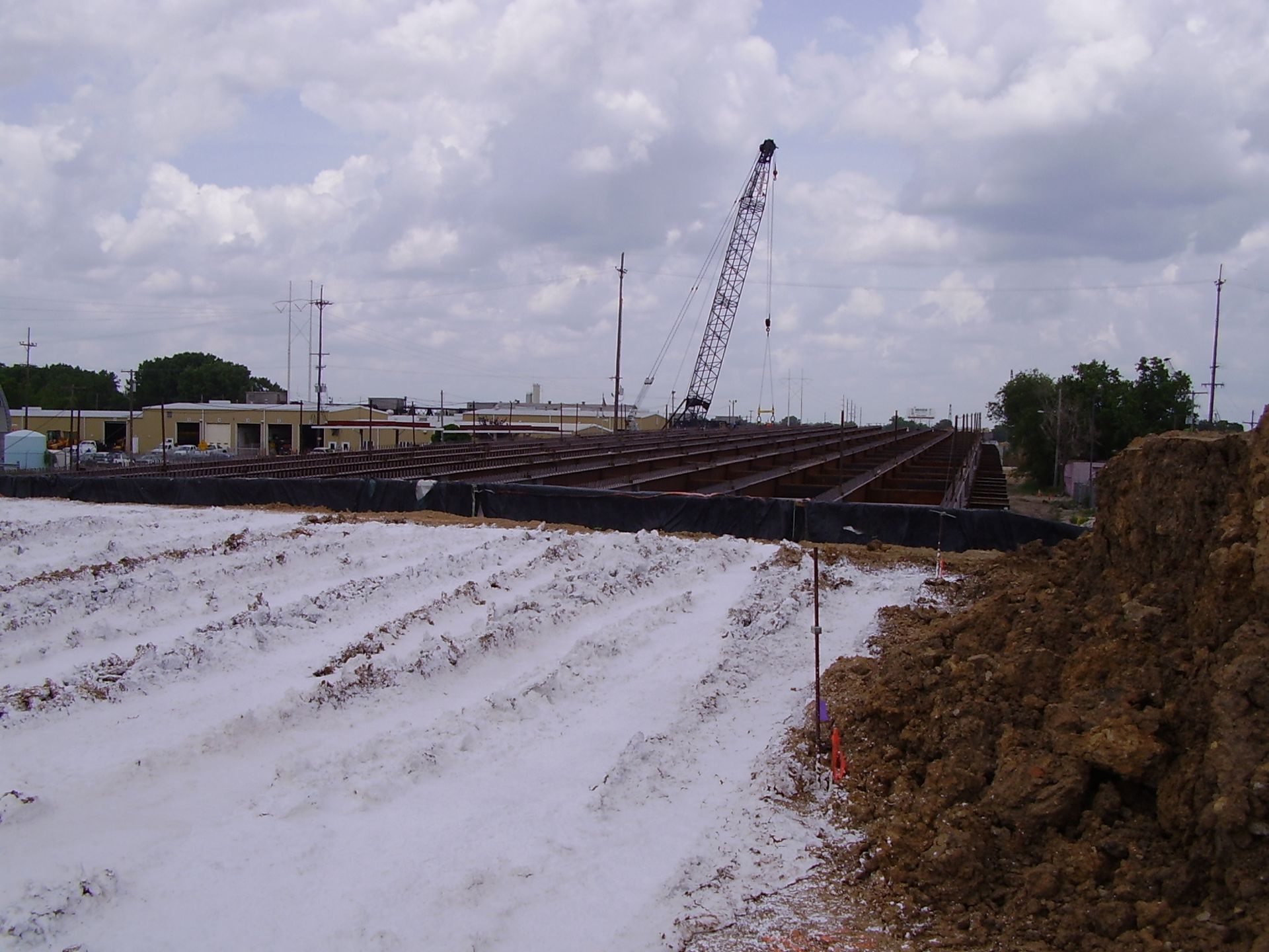 A construction site with a large crane in the background