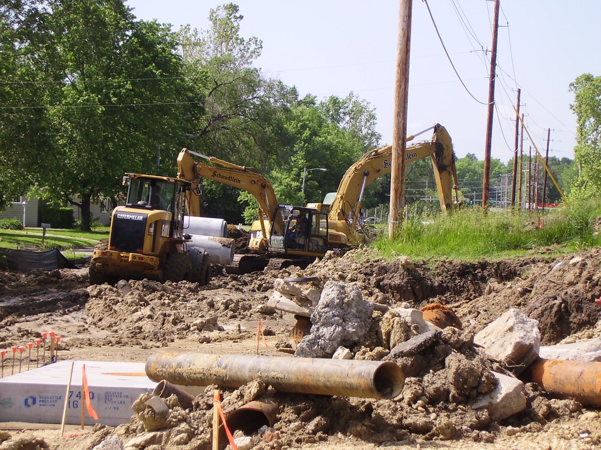 Two bulldozers are working on a construction site