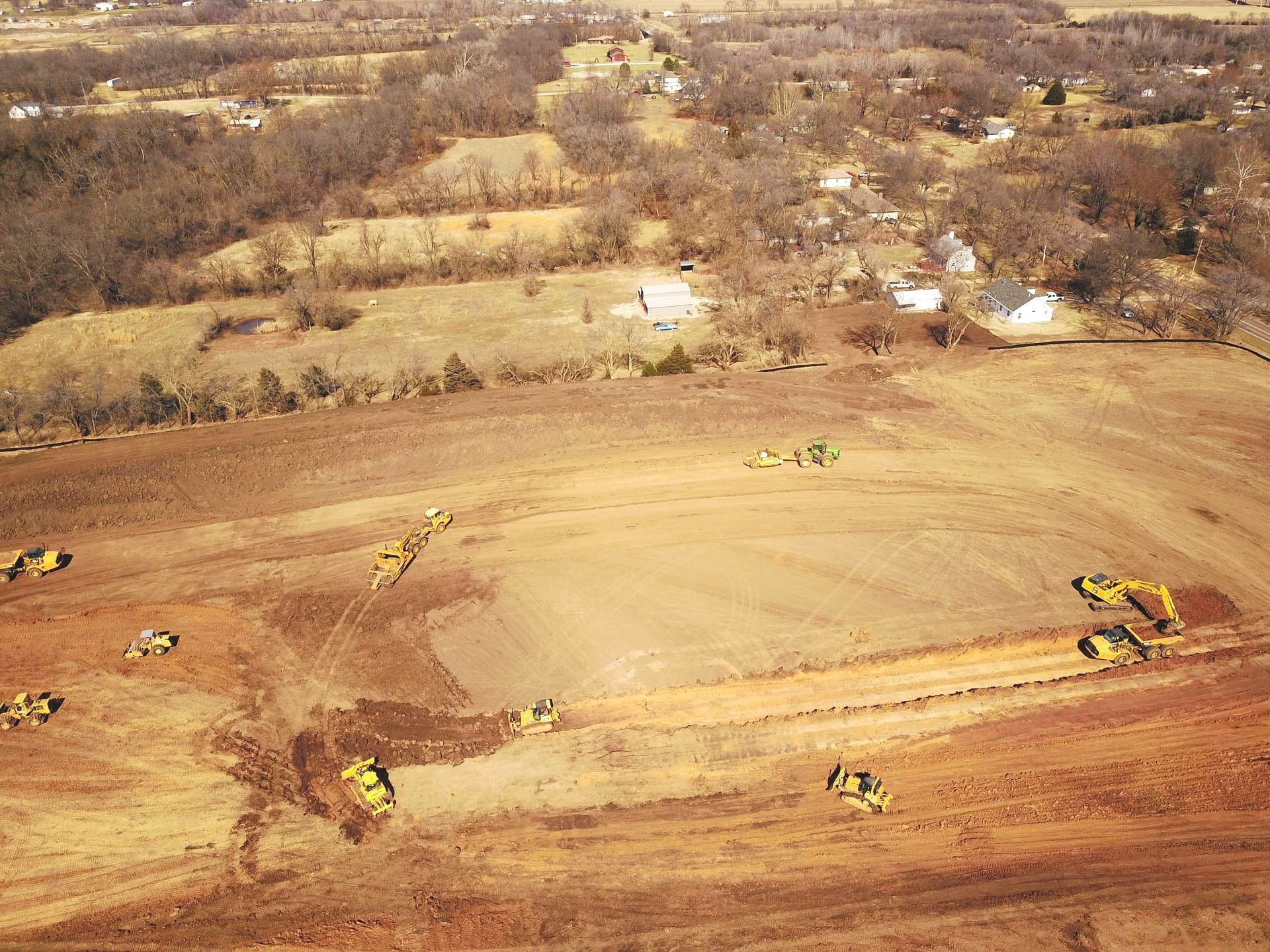 An aerial view of a construction site with tractors and bulldozers