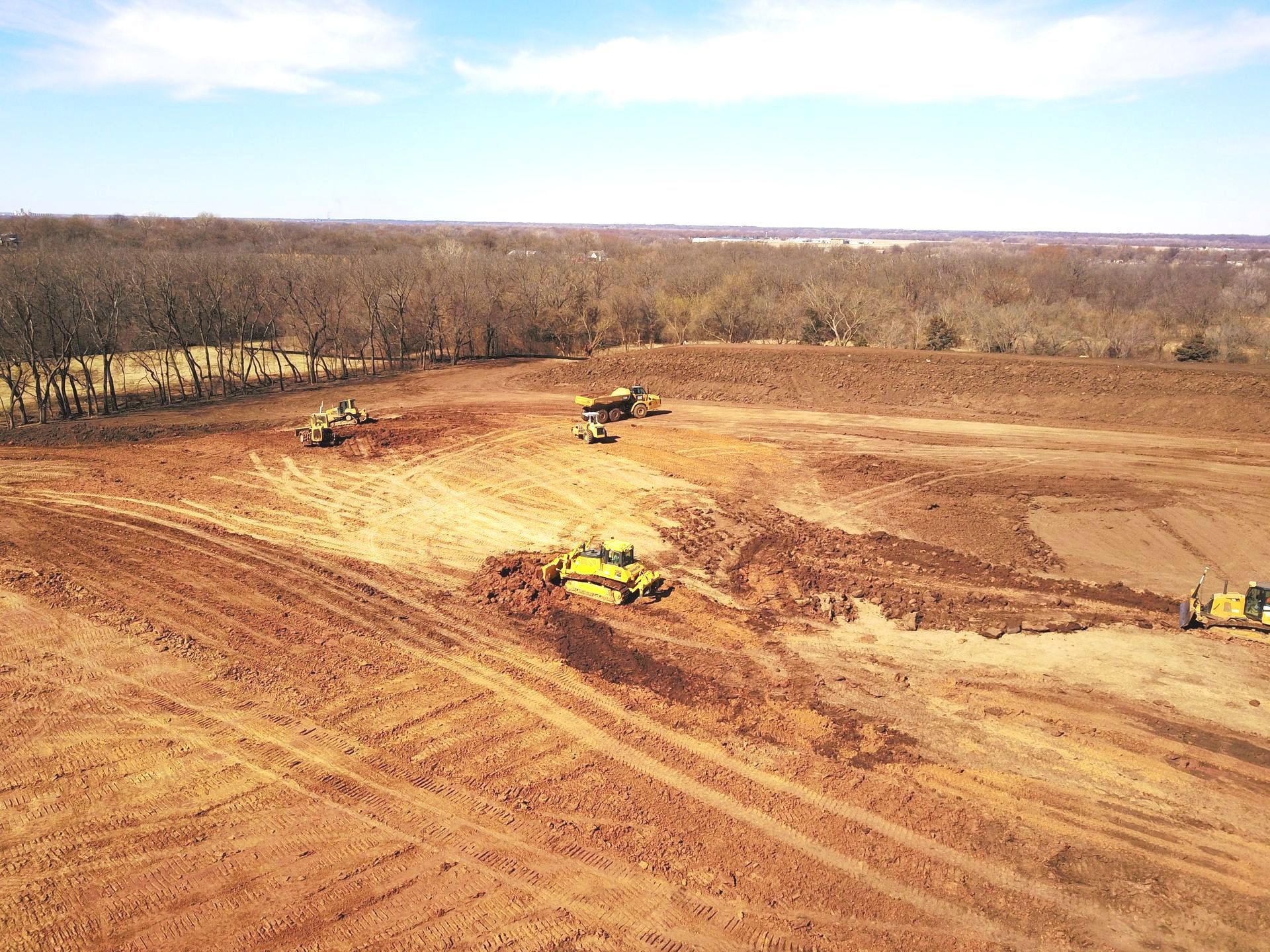 An aerial view of a construction site with tractors and bulldozers.