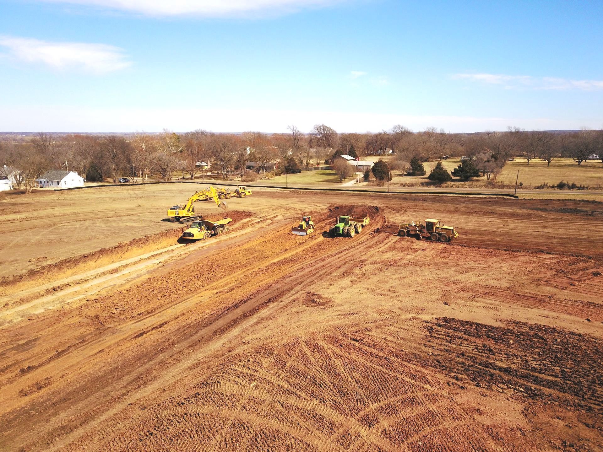 An aerial view of a construction site with tractors and bulldozers.