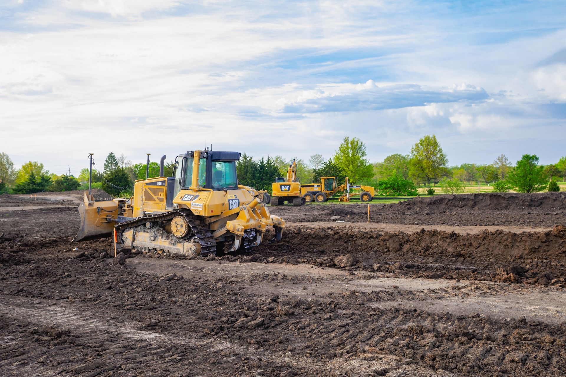 A bulldozer is moving dirt on a construction site.