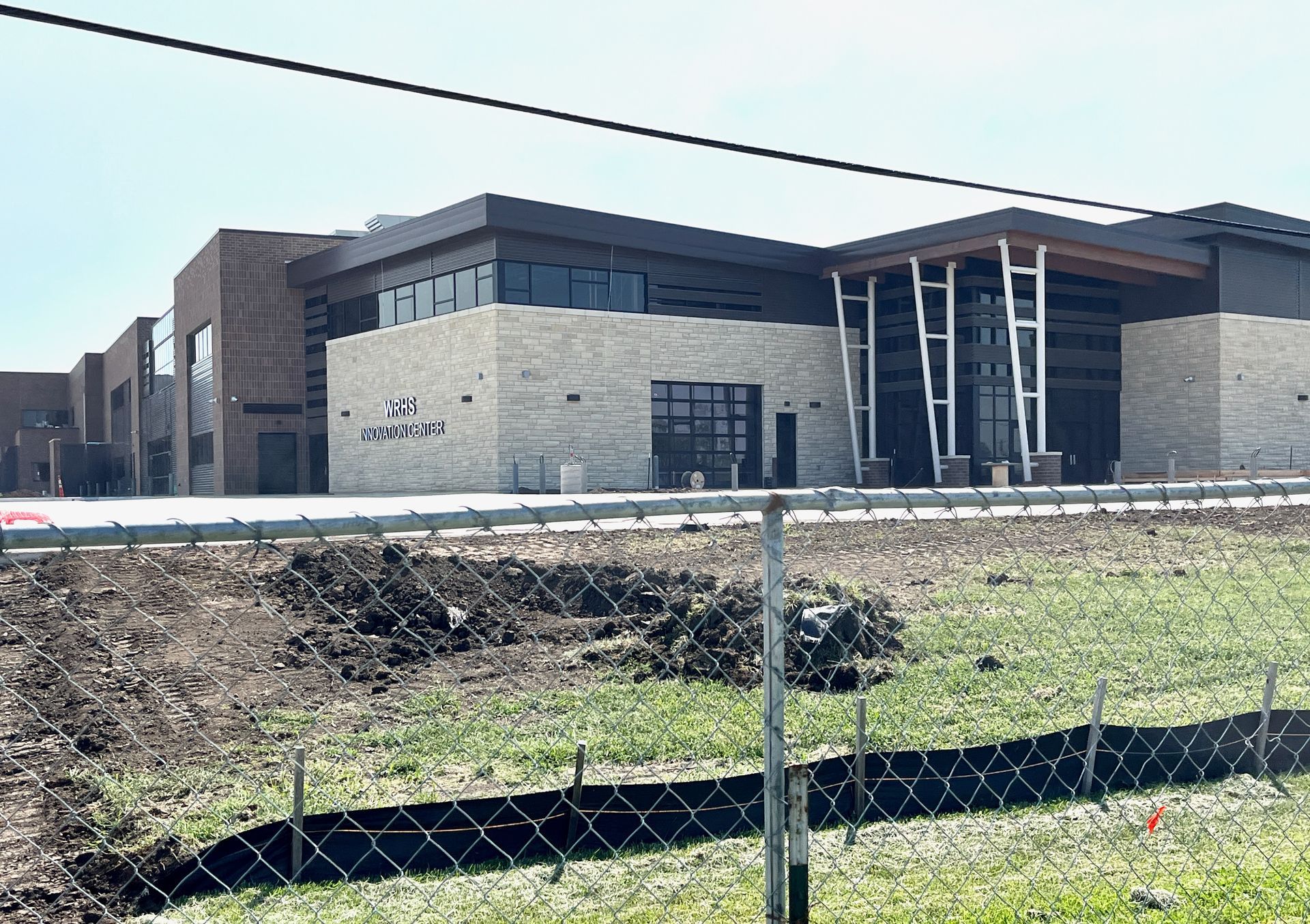 A large building with a chain link fence in front of it