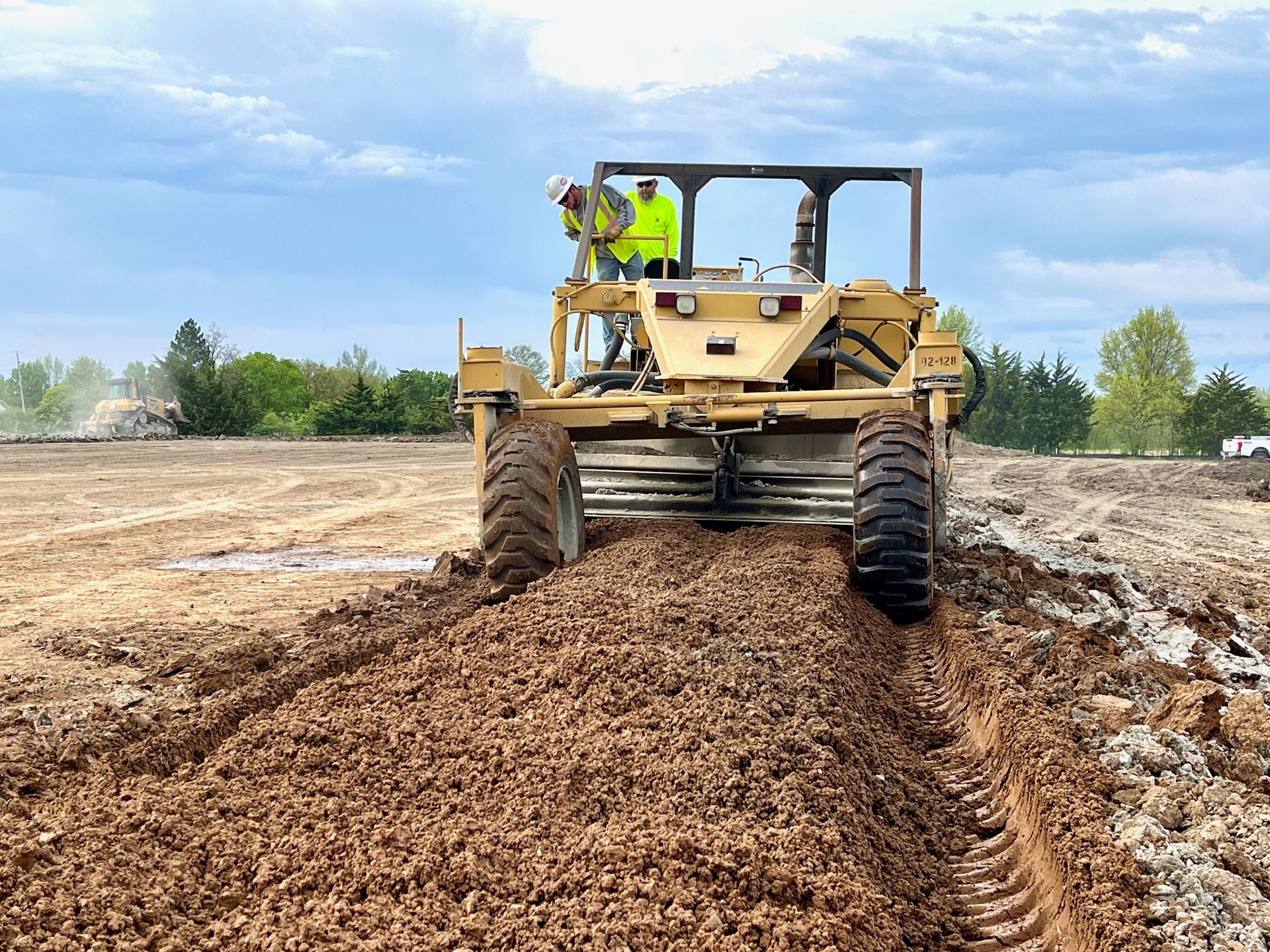 A bulldozer is moving dirt in a field.