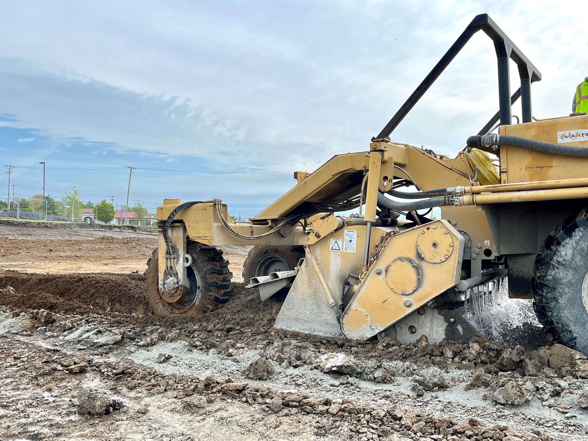 A bulldozer is moving dirt in a muddy field.