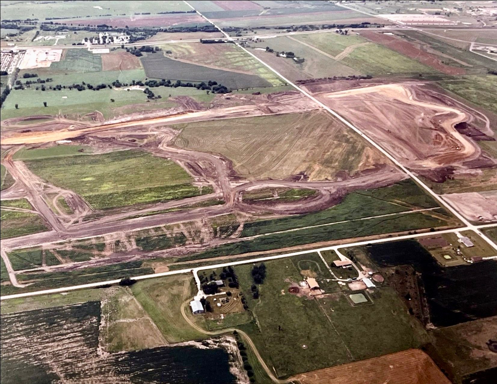 An aerial view of a construction site with lots of dirt and grass