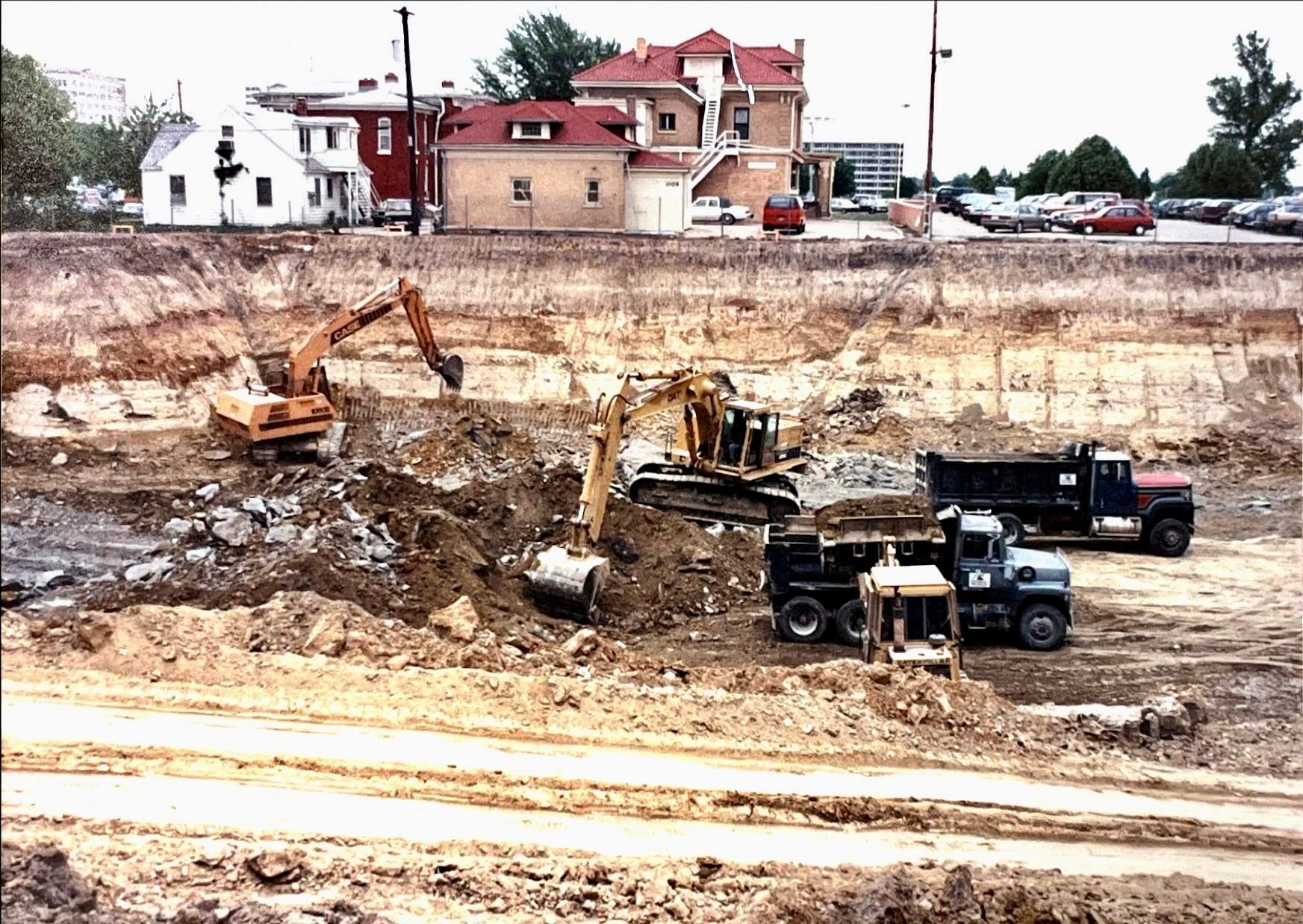 A construction site with a house in the background