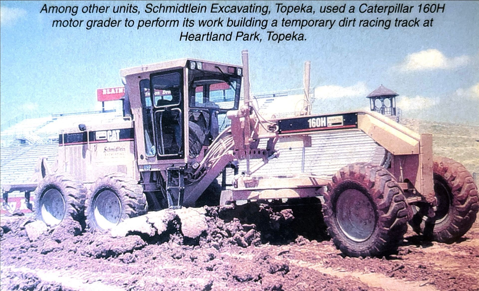 A black and white photo of a caterpillar grader