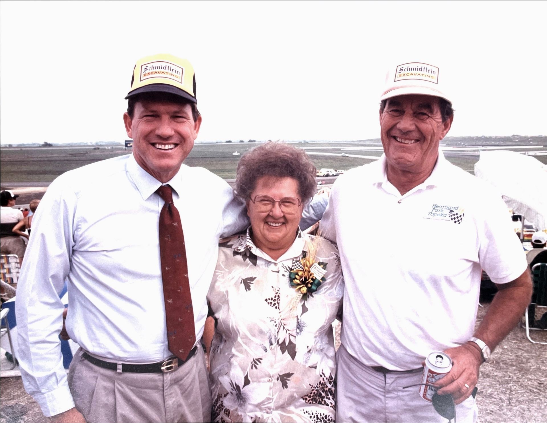 Two men and a woman are posing for a picture together