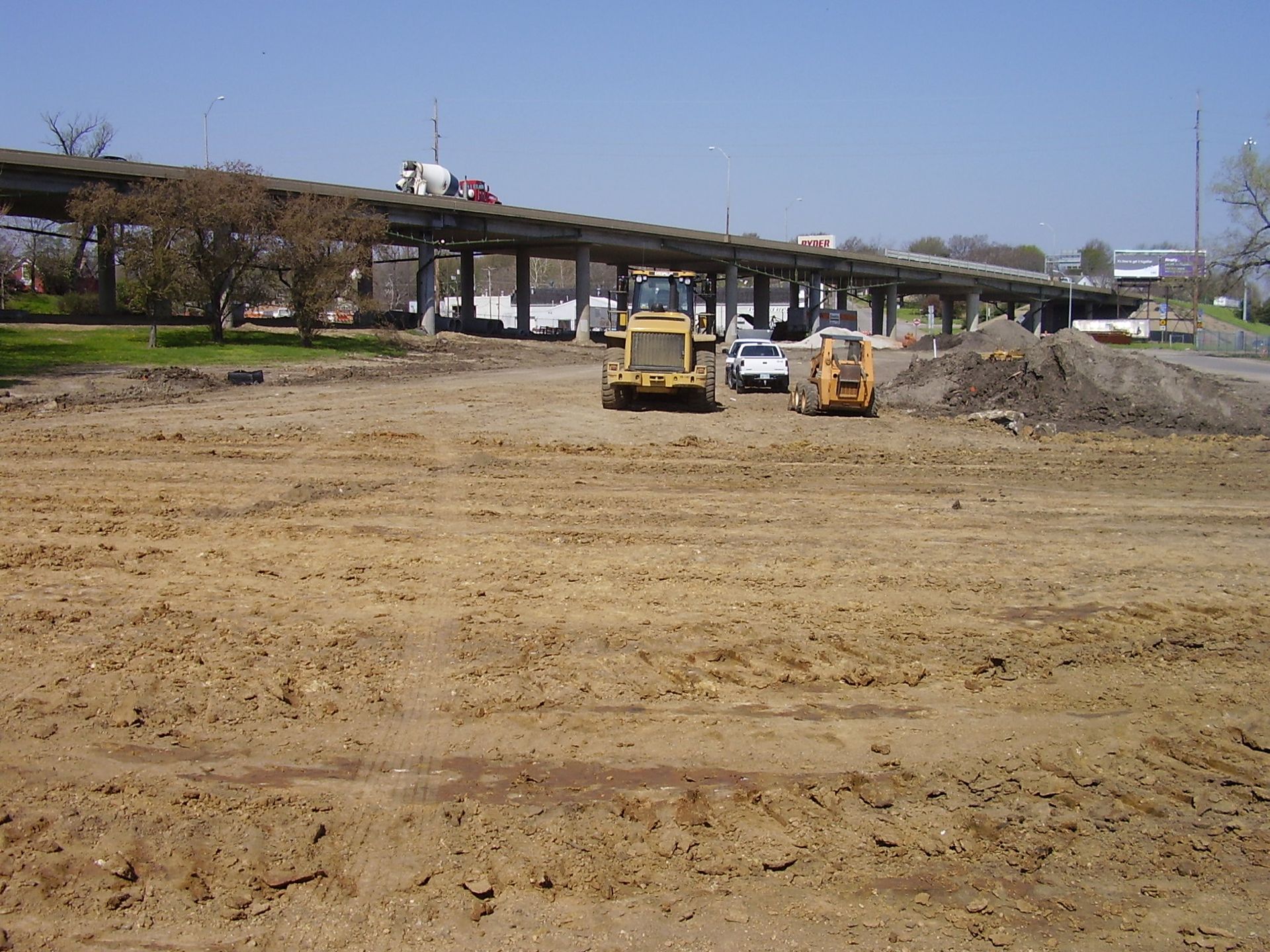 A construction site with a bridge in the background