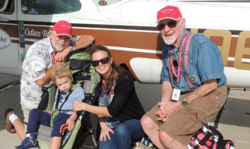 Nevin Showman (left) and Capt. John Billings (right) in front of their plane, 49Bravo.