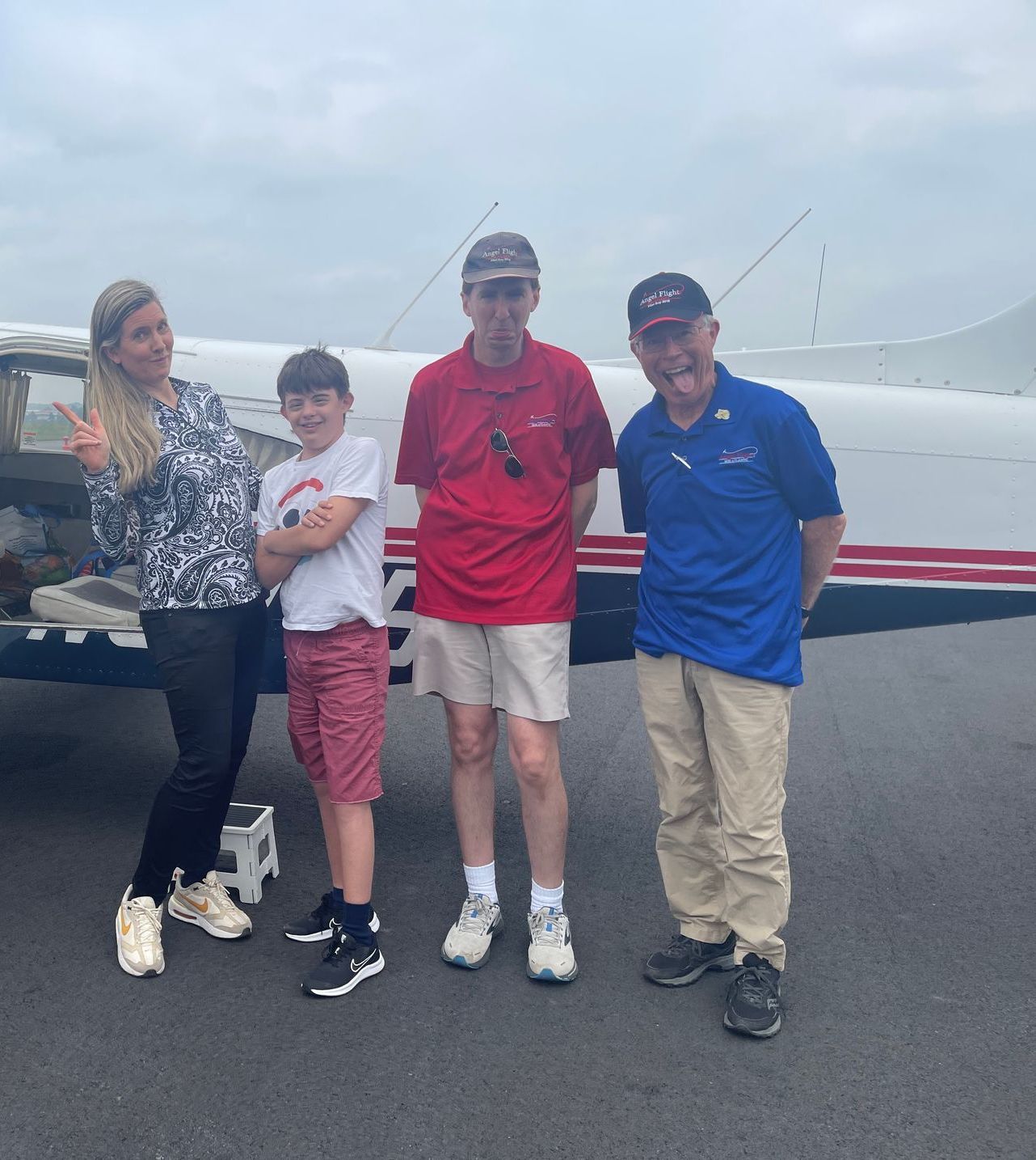 Disabled teen with his mom and volunteer pilots