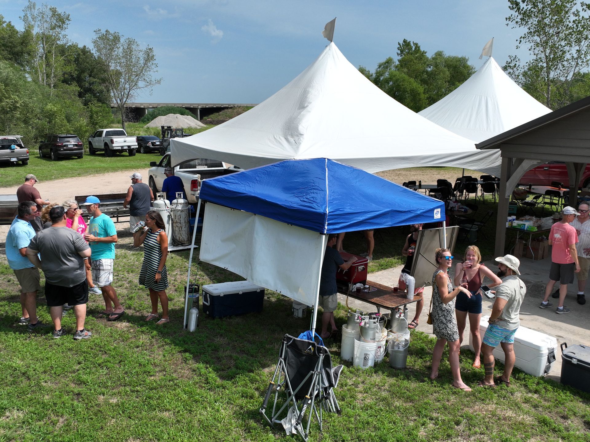 Arial view of the ICL family picnic showing two large white tents and a small blue tent.