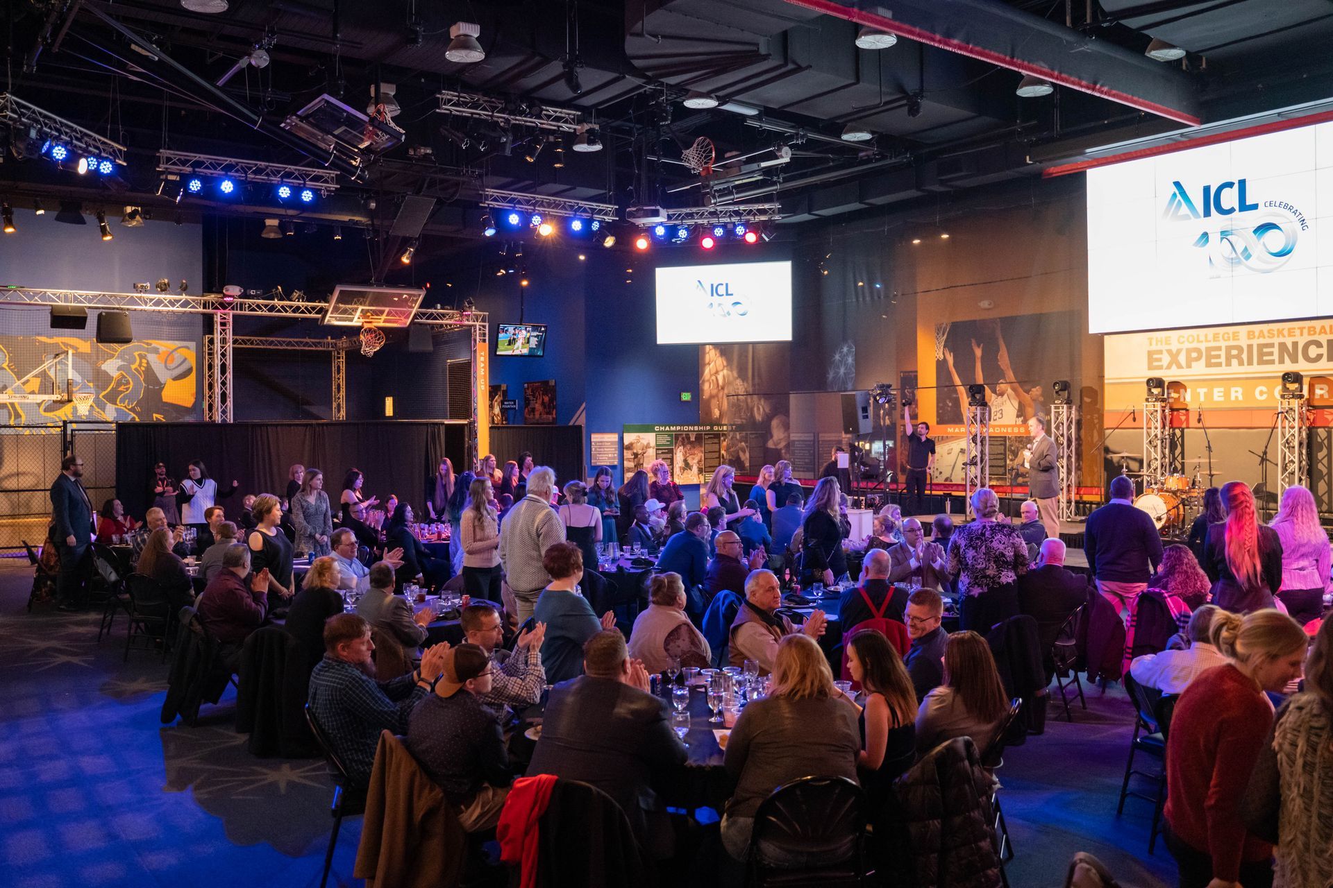 People are sitting at tables at the ICL party.