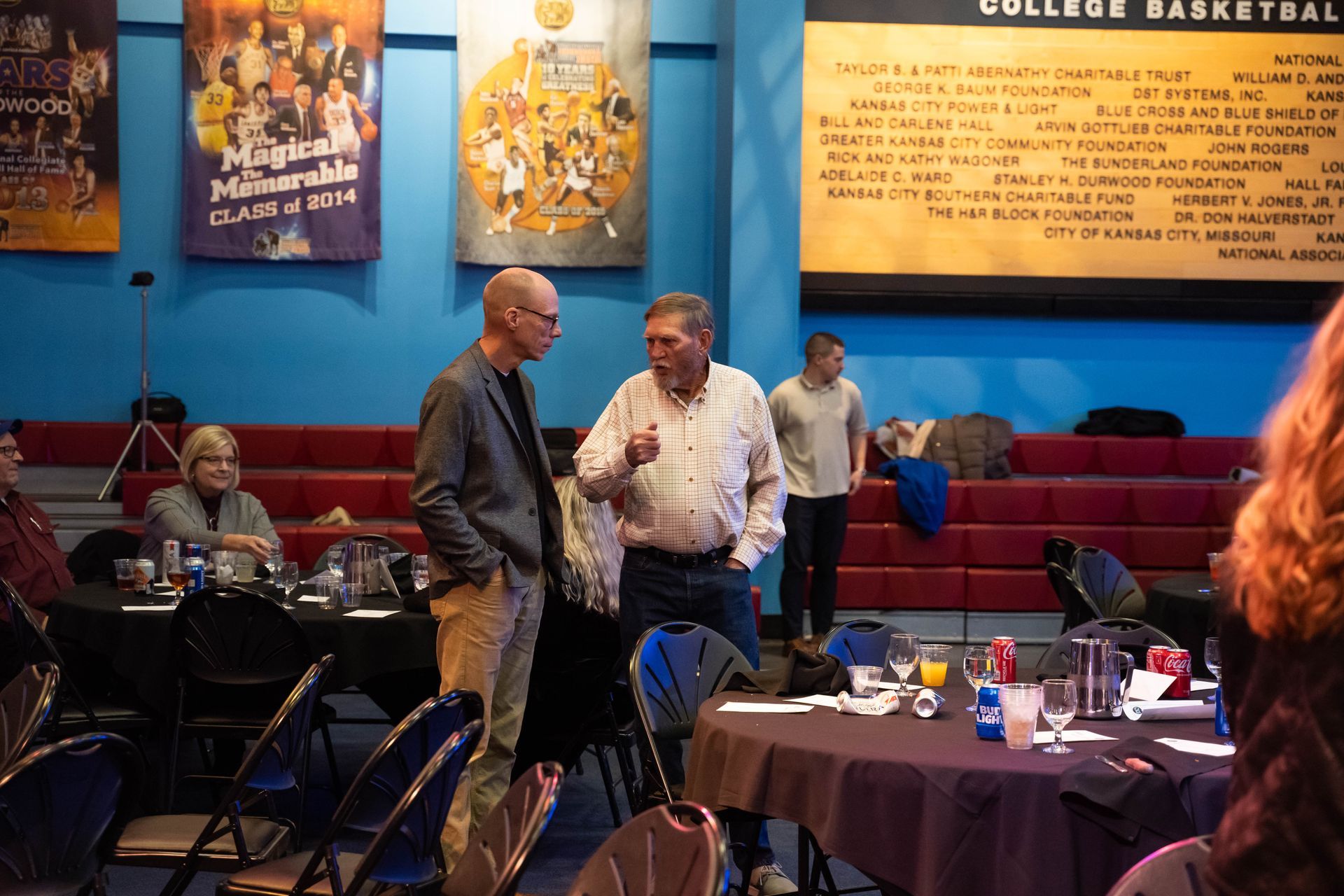 Two men are talking at the party.