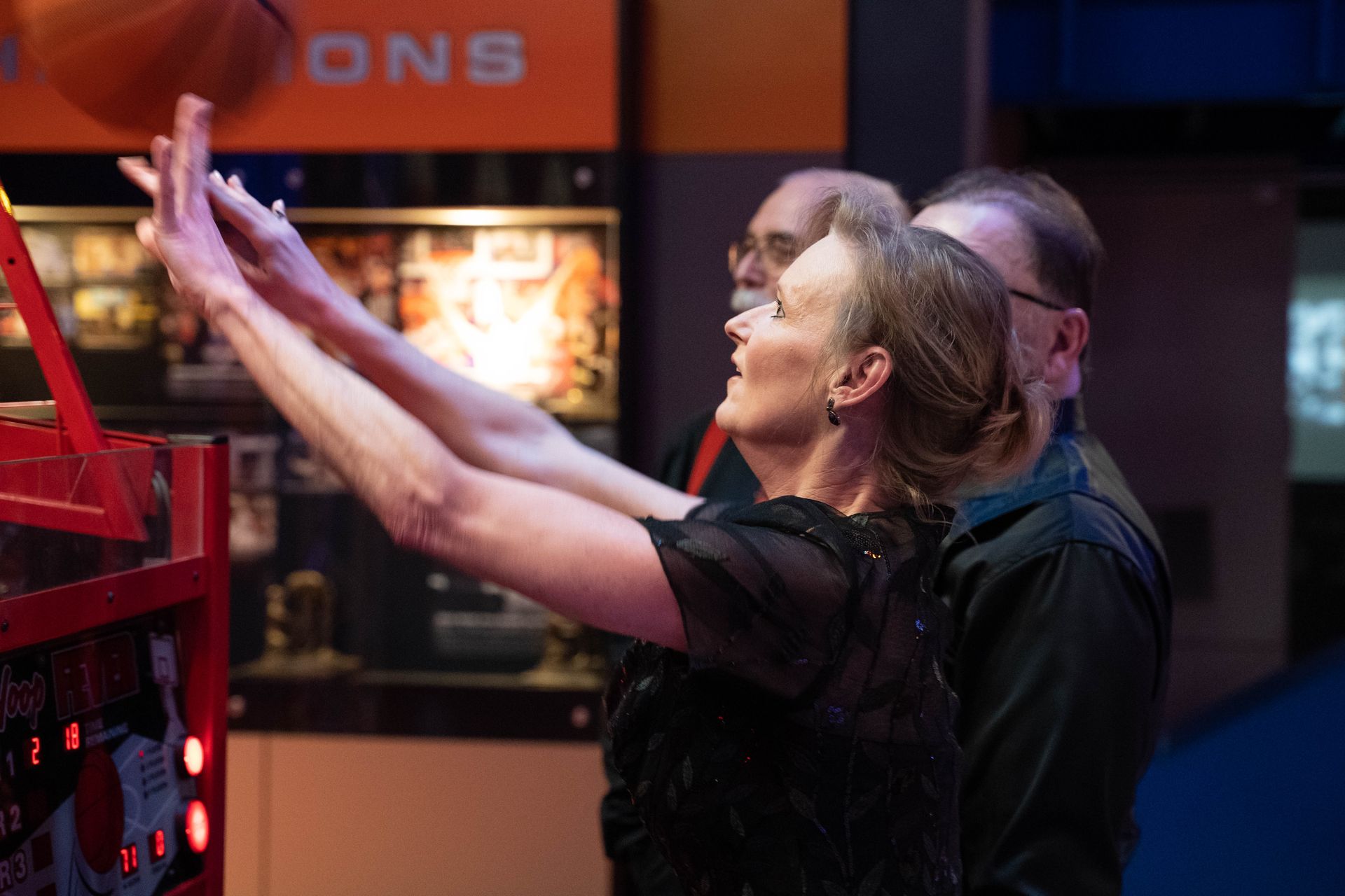 A woman just threw a basketball in the hopp game.