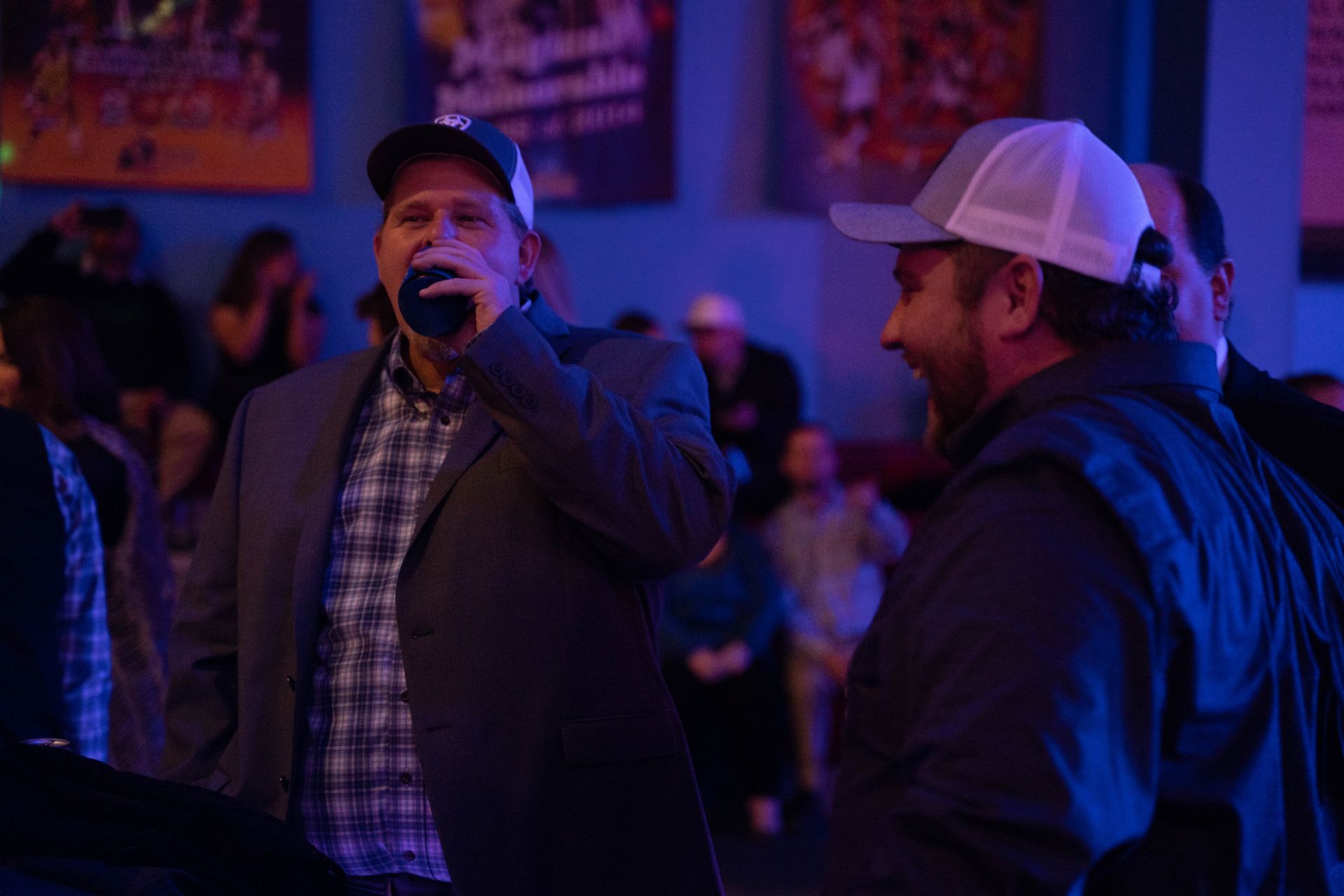 Two men are standing and dringin