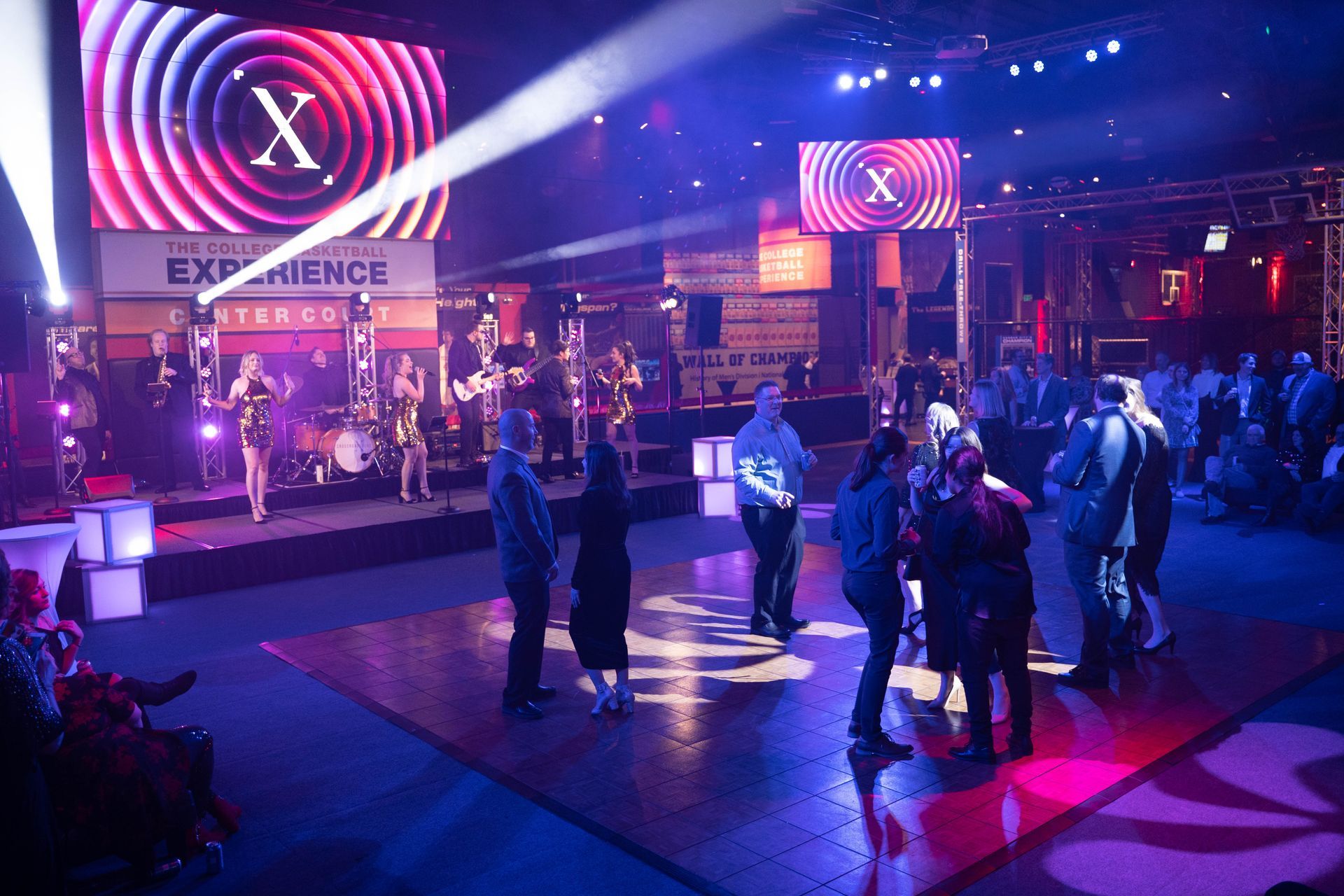 Scattered few people on the dance floor of the party.