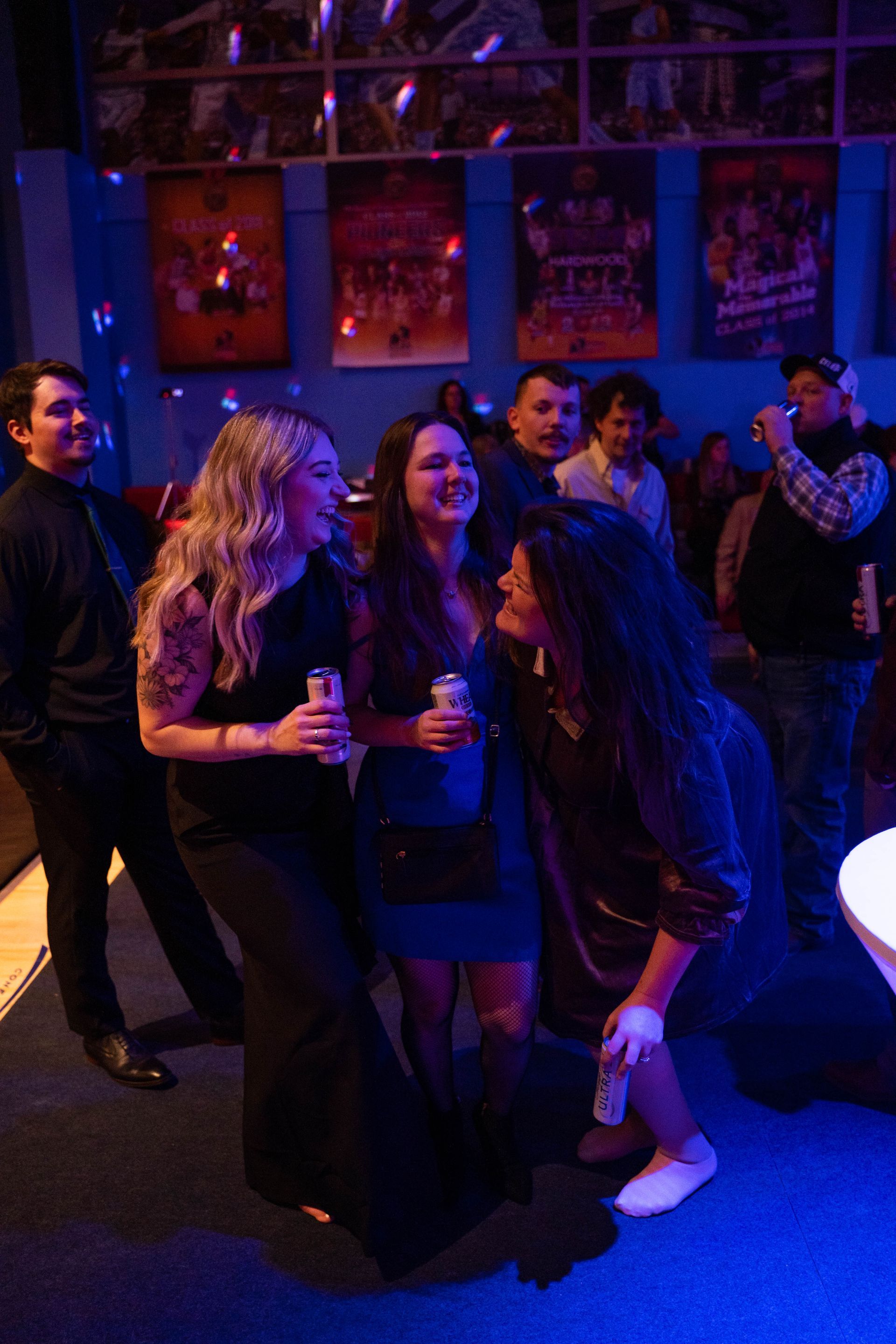 Women are standing around laughing at the party for ICL