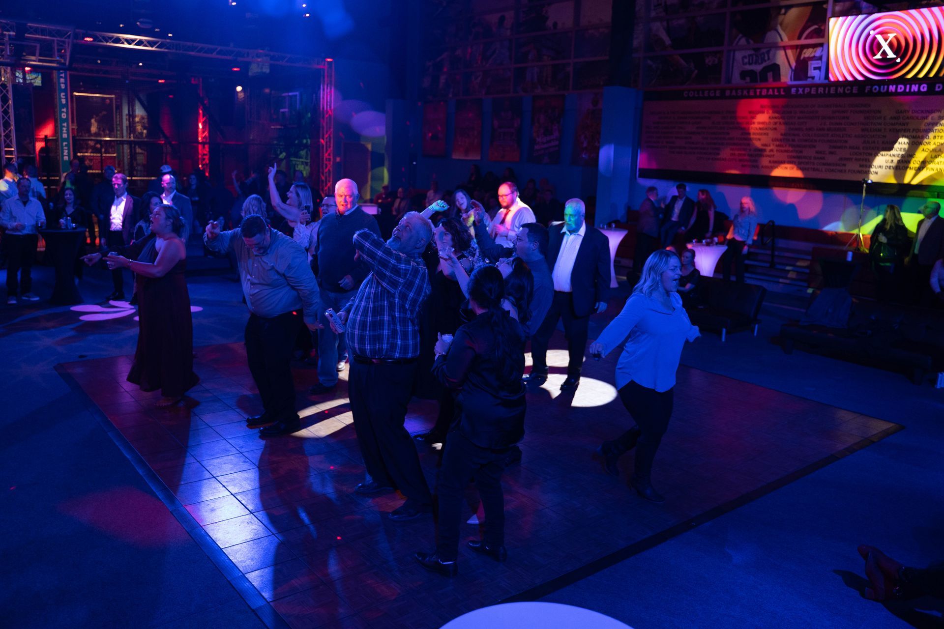 People are dancing on the dance floor with their arms raised. at the ICL party.