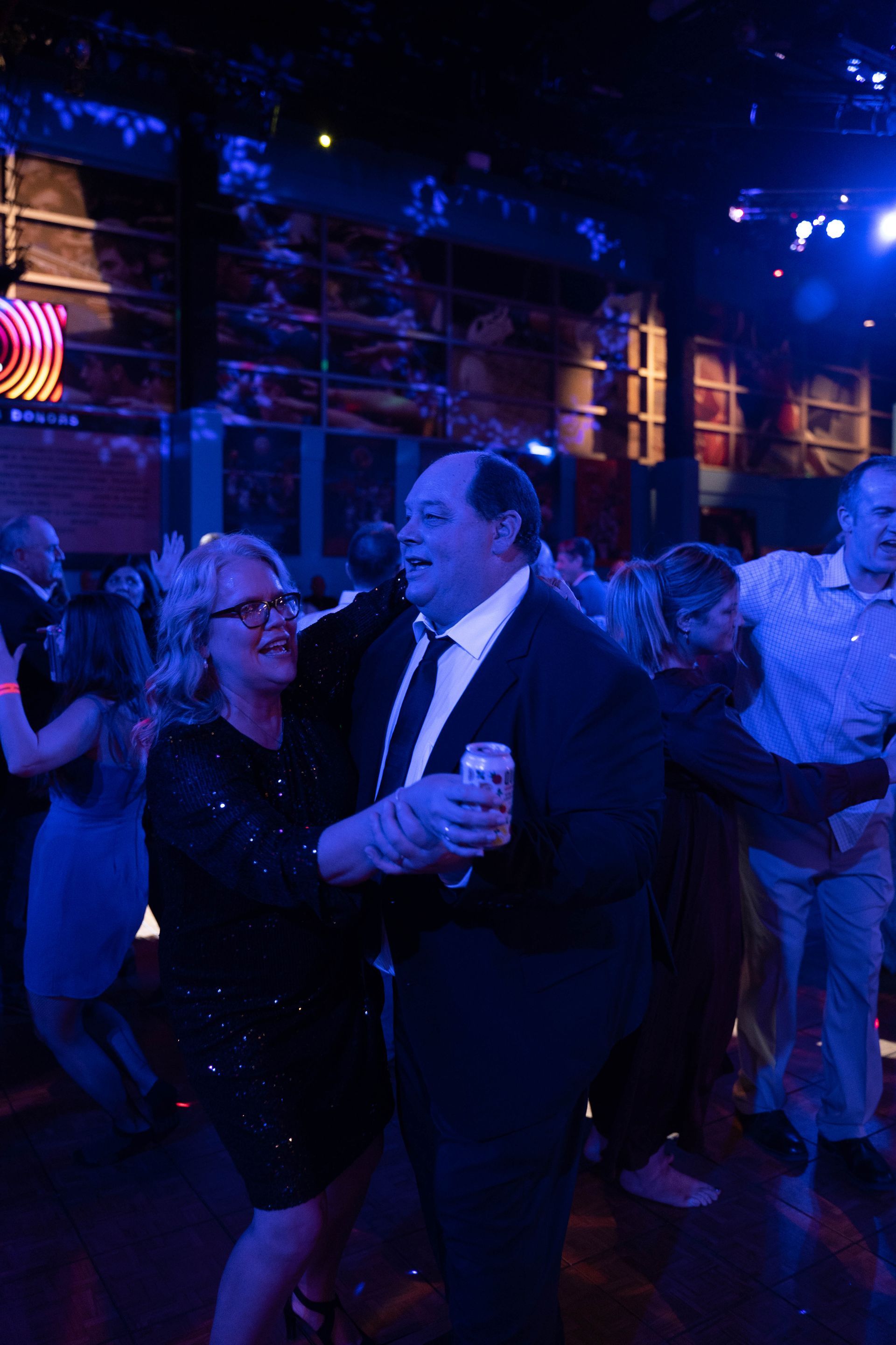 A woman and man are dancing and talking at the 100 year anniversary party for ICL