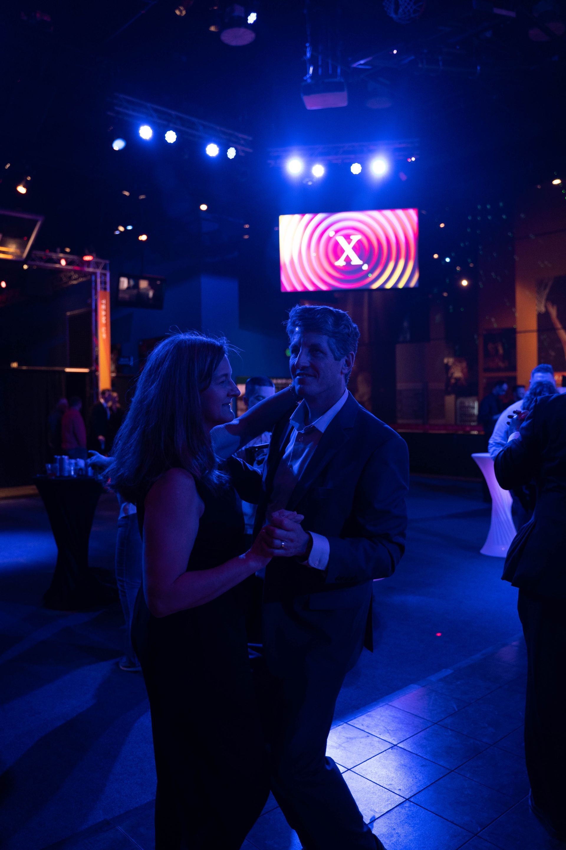 a nice couple is dancing on the dance floor at the anniversary party.