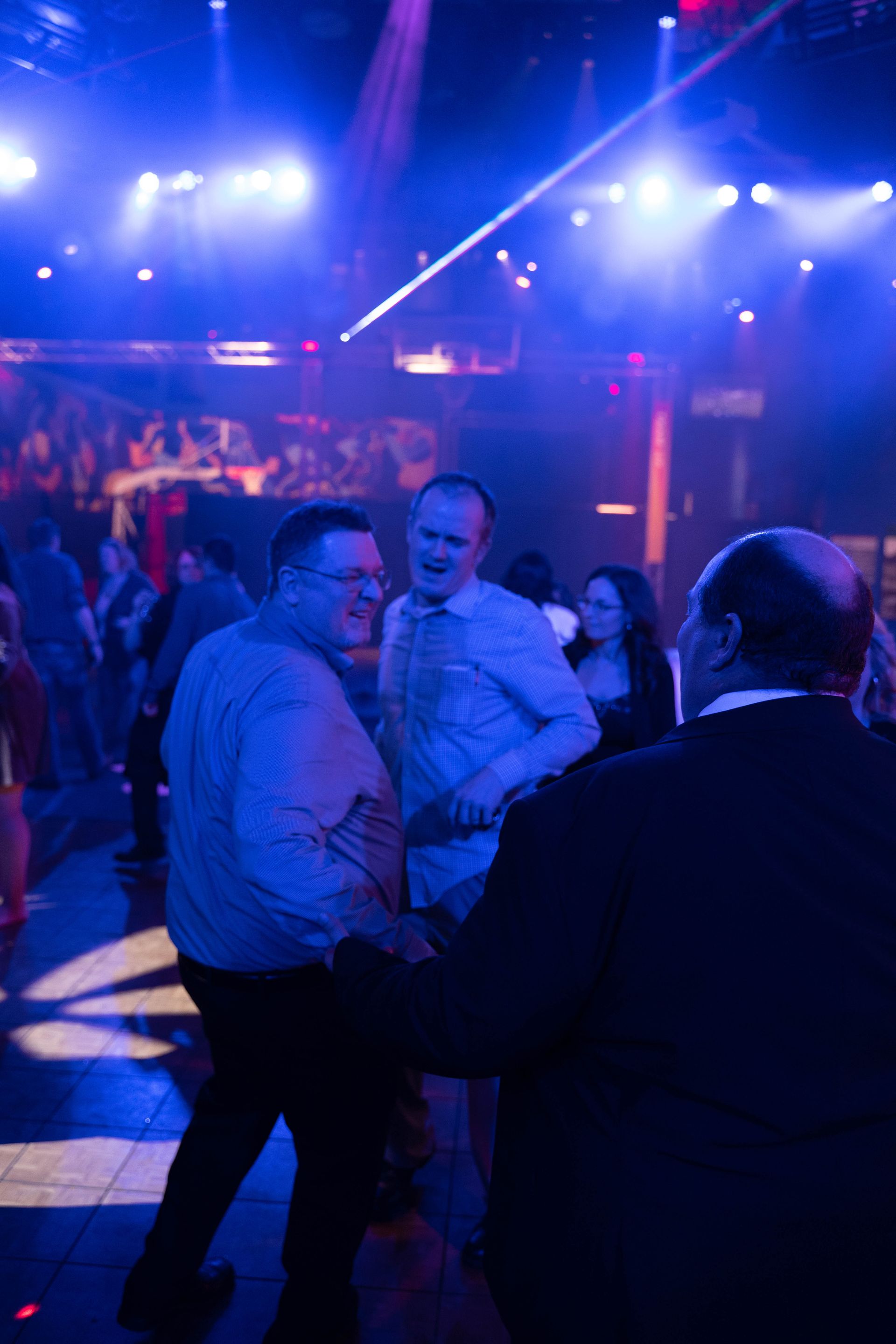 people standing around talking at the 100 year anniversary party