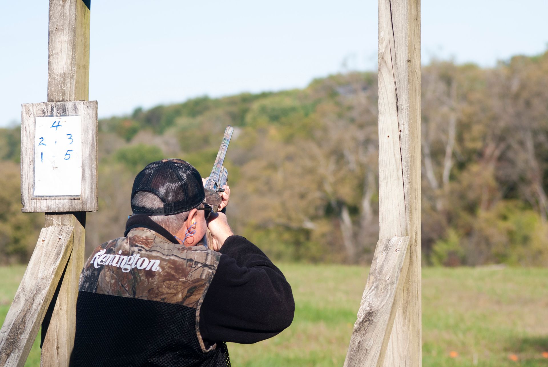 A man points a hun to skeet shoot.