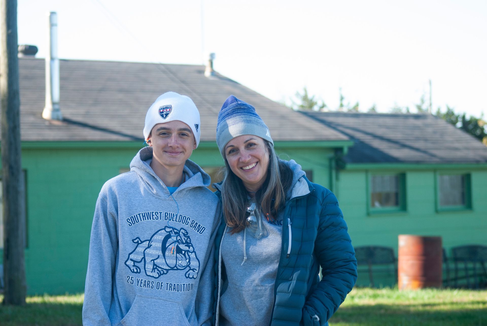 A mother and son smile for the camera at the skeet shoot.