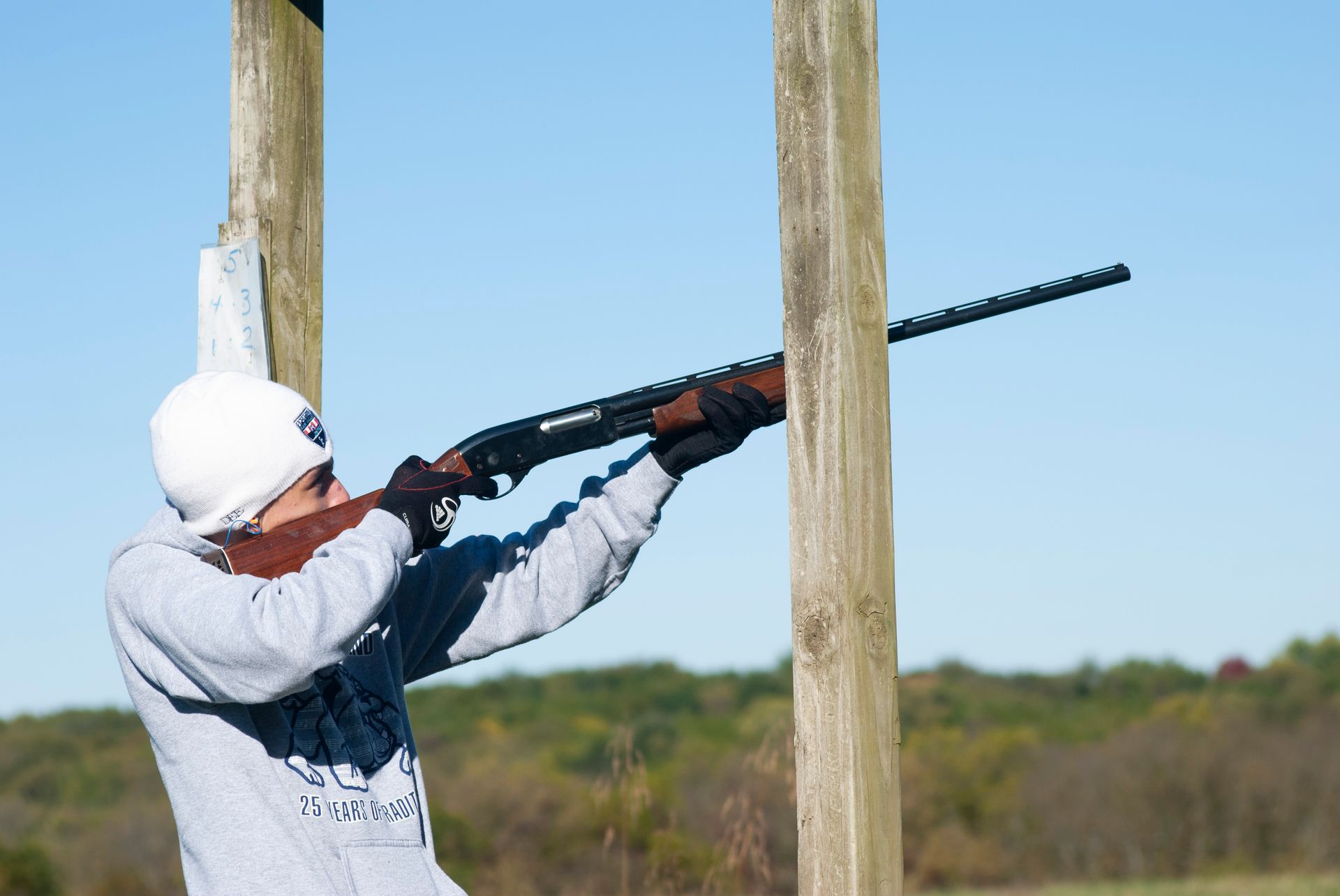 A man points a gun at the skeet shoot.
