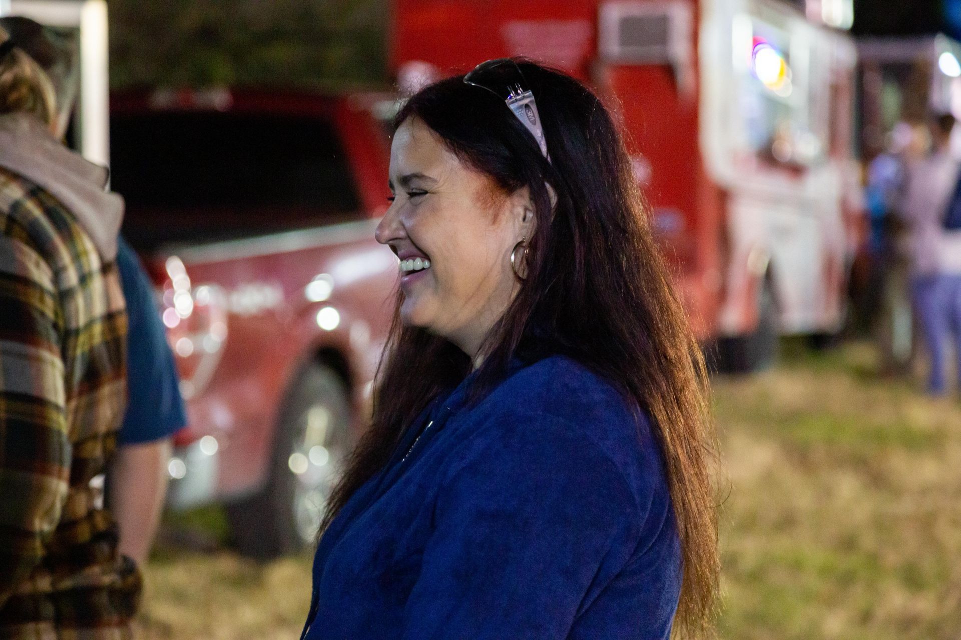 A woman is standing and laughing.