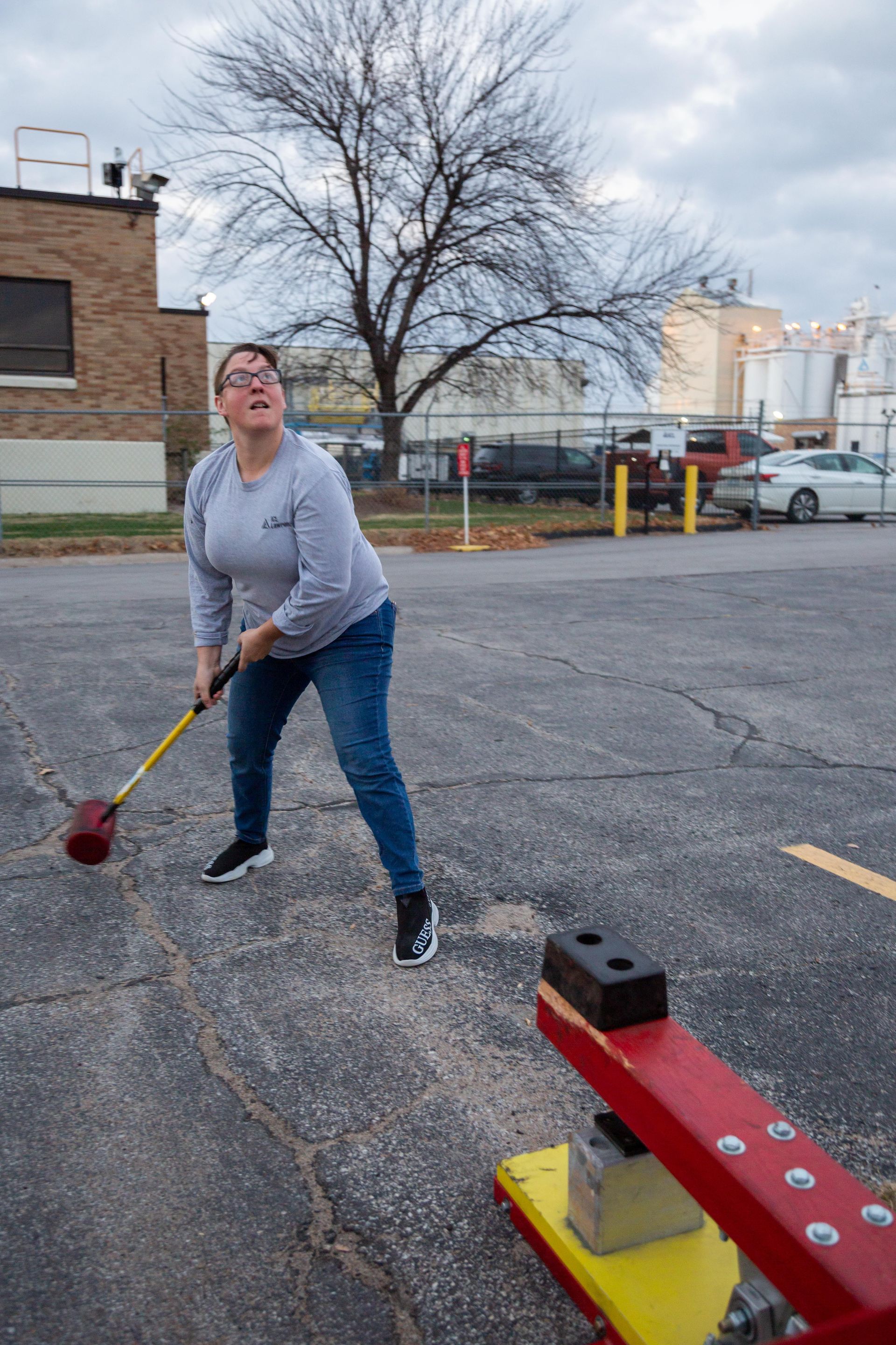 At the ICL fall family picnic has a large hammer and tried to hit a game hard to make a metal ball go up and chime a bell.