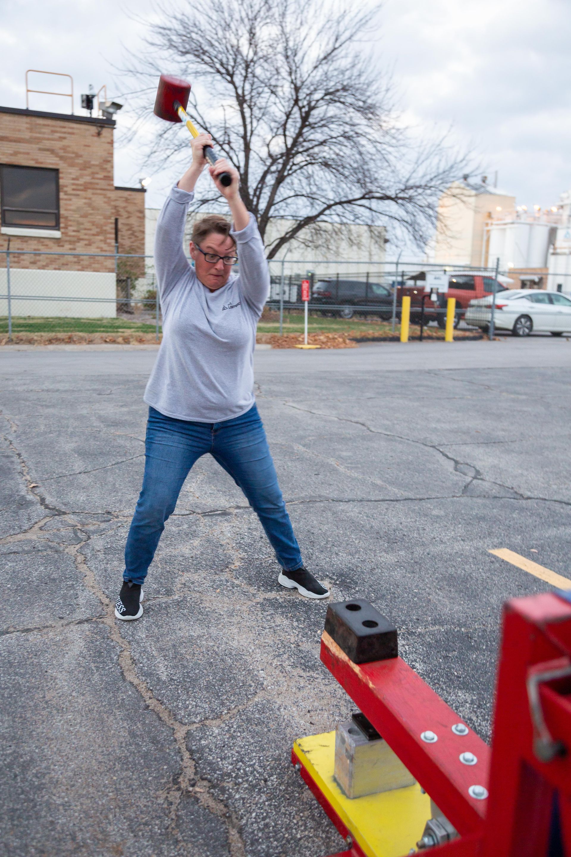 At the ICL fall family picnic has a large hammer and tried to hit a game hard to make a metal ball go up and chime a bell.