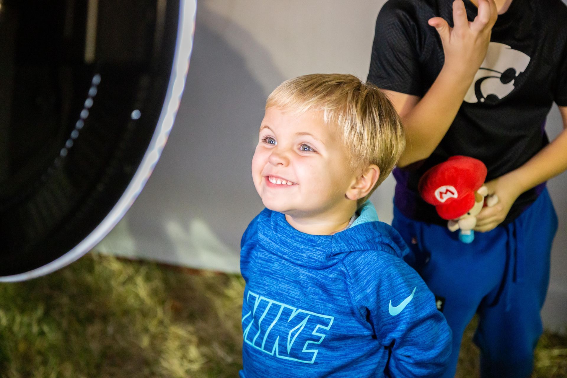 A cute little boys smiles with a silly face.
