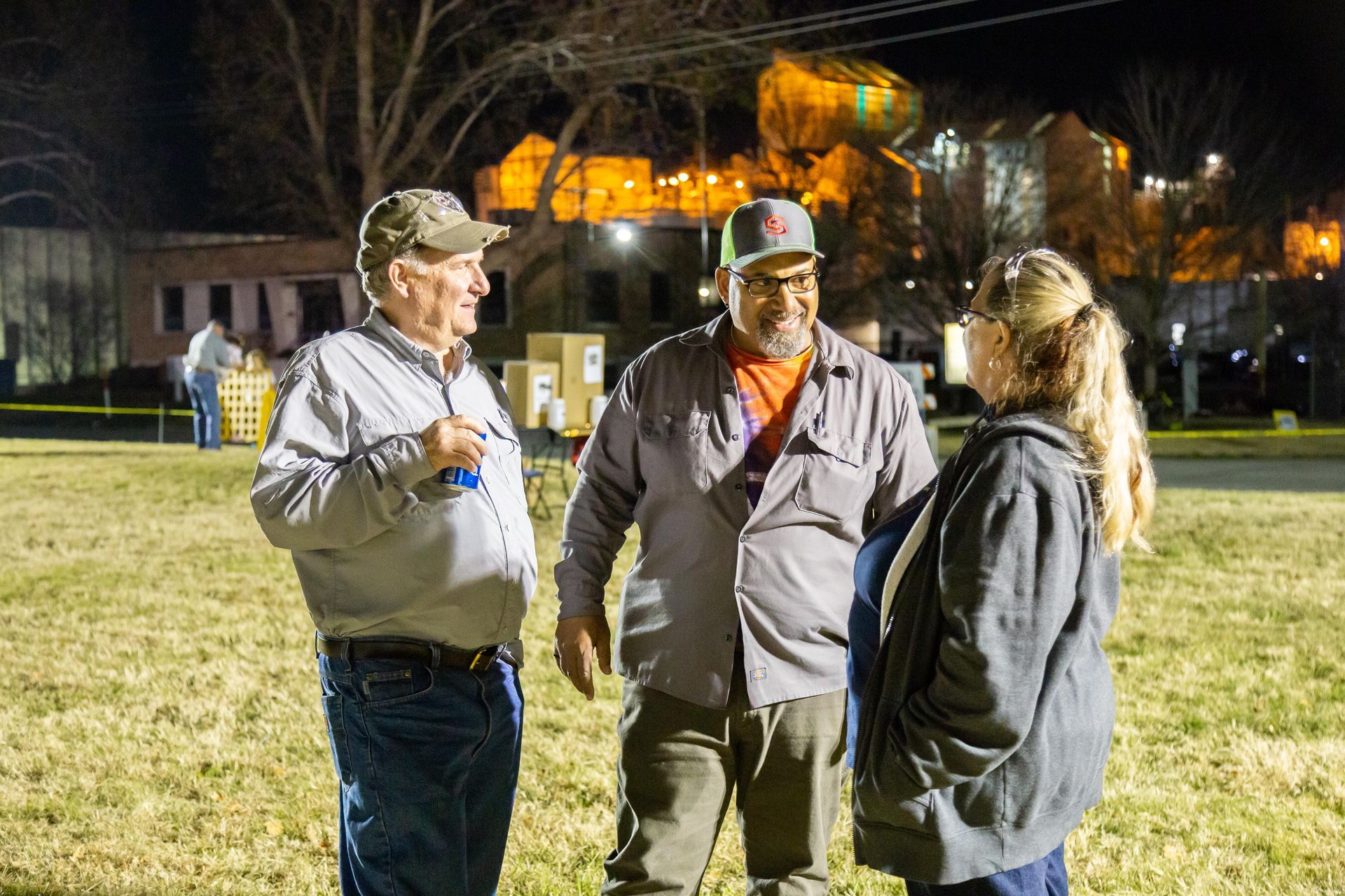 People stand around and laugh at ICL's fall family picnic.